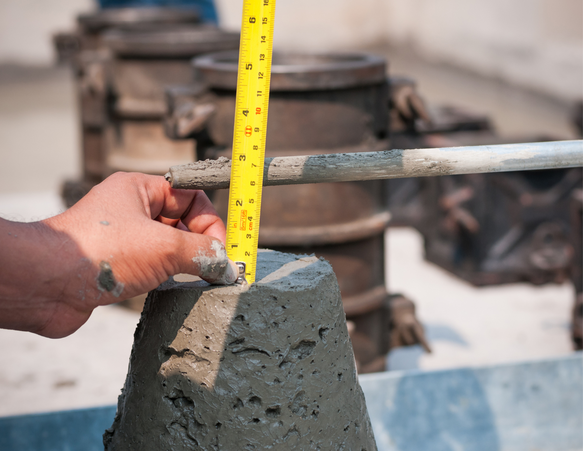 Concrete slump testing being performed to evaluate fresh concrete during construction.