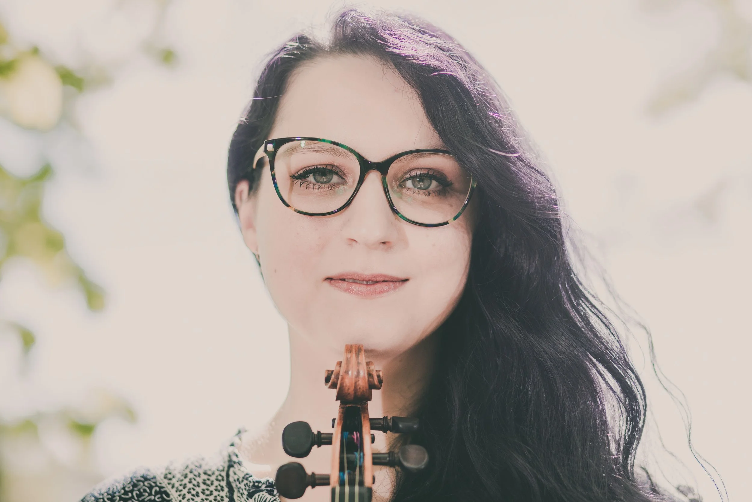 Close-up of Katy Smith violinist holding violin scroll under her chin
