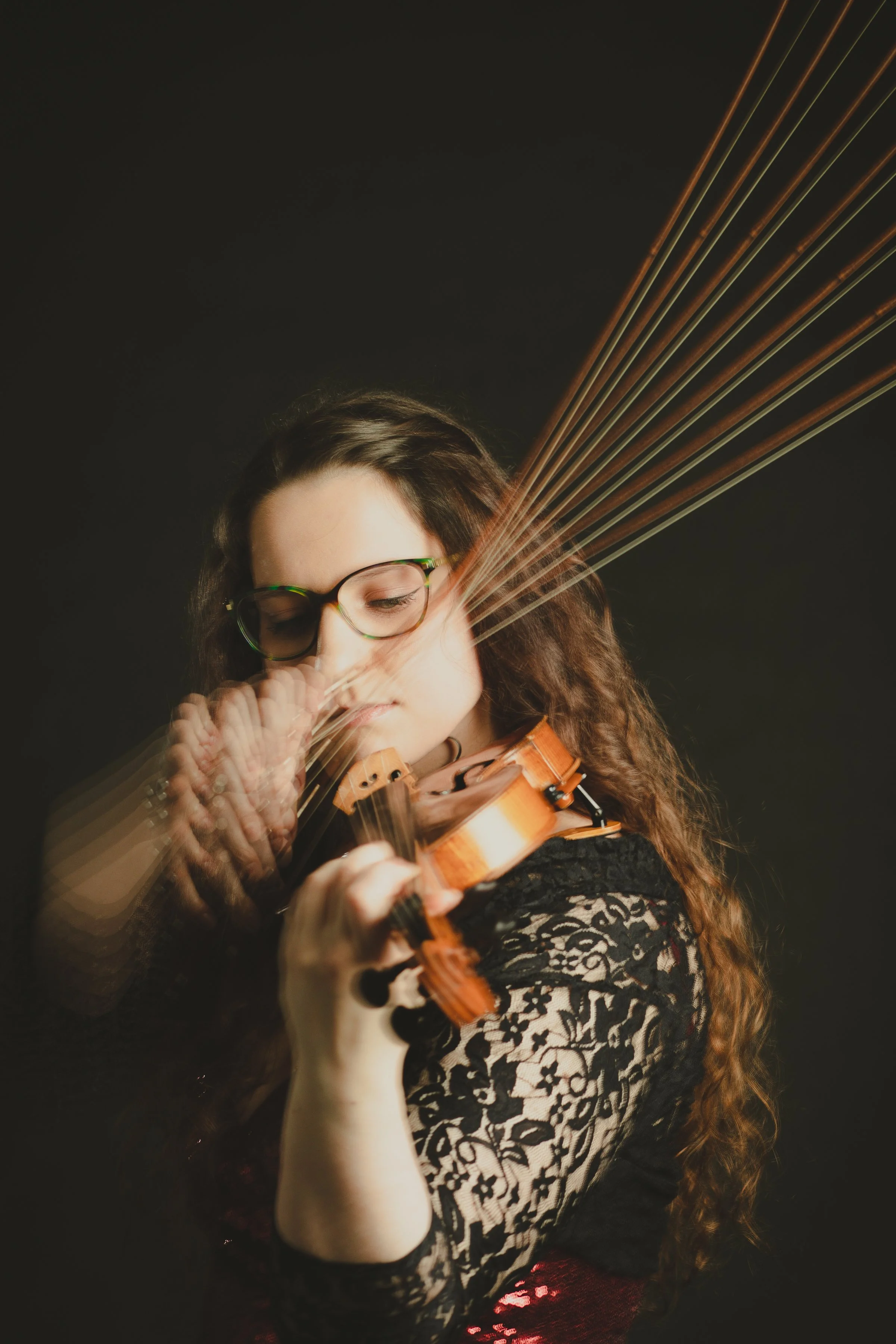 Studio photograph of Katy Smith Violinist playing violin with special effects