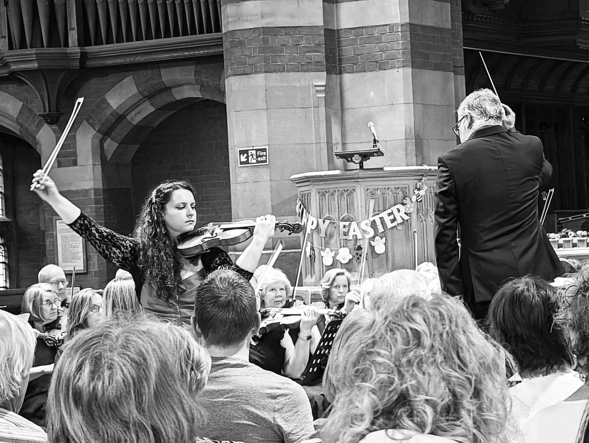 Katy Smith violinist mid performance of Tchaikovsky Concerto with Worcestershire Symphony Orchestra and conductor Keith Slade