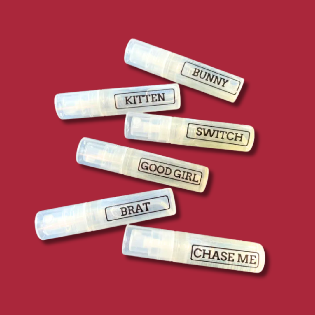 mini perfume bottles on burgundy background