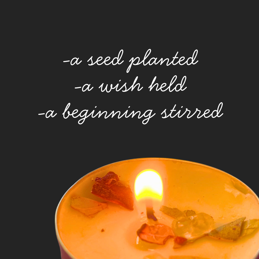 A lit candle with dried flower petals and herbs on top, against a dark background with text about planting a seed, holding a wish, and stirring a beginning.