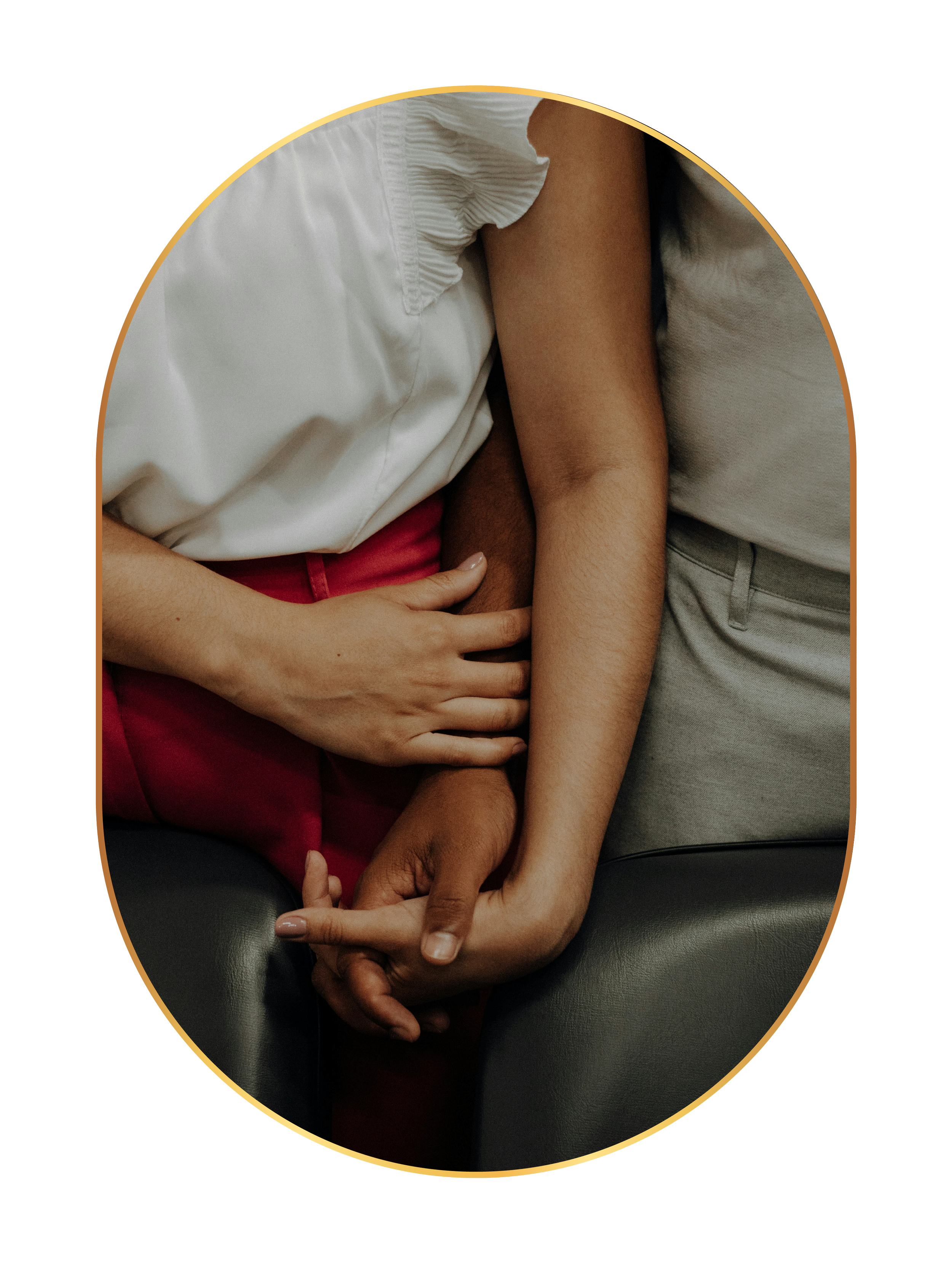 Close-up of two people holding hands, showing diverse skin tones, with one person resting their hand on another's arm.