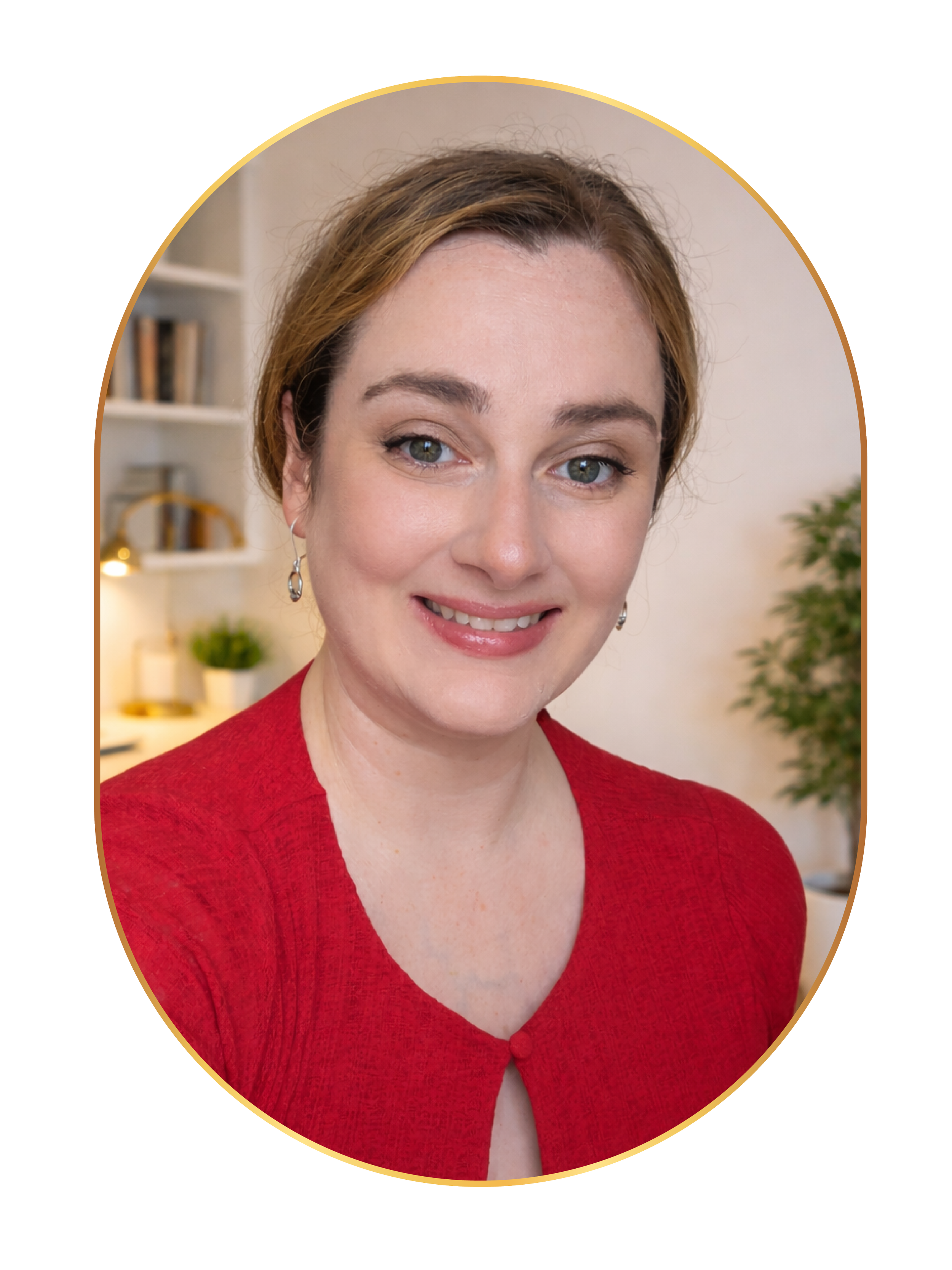 Close-up portrait of a woman with blonde hair pulled back in a ponytail, blue eyes, and a friendly smile, wearing a red top, in a warmly lit indoor setting with shelves and plants in the background.