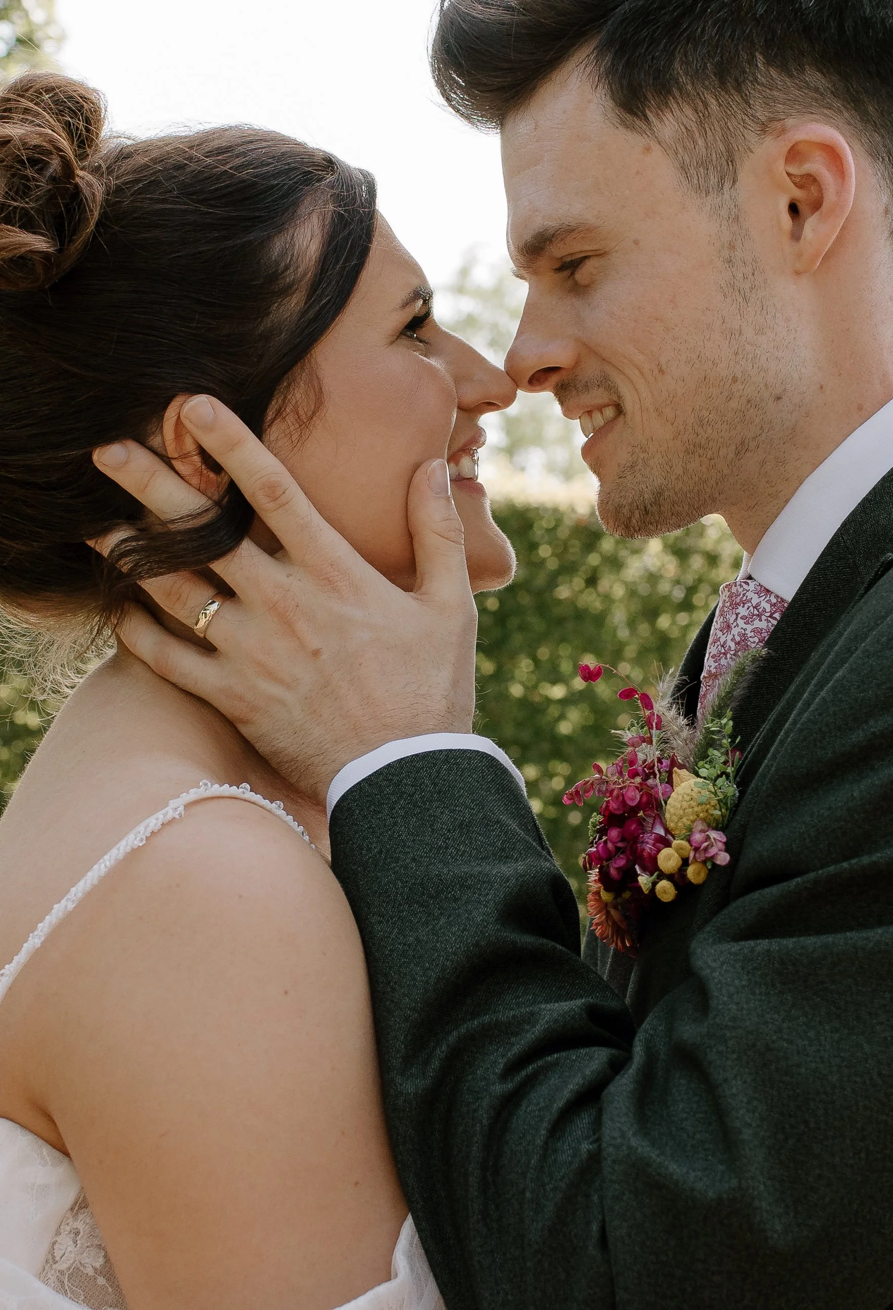 Intimate close-up wedding portrait of a bride and groom sharing a quiet moment during a Somerset countryside wedding.