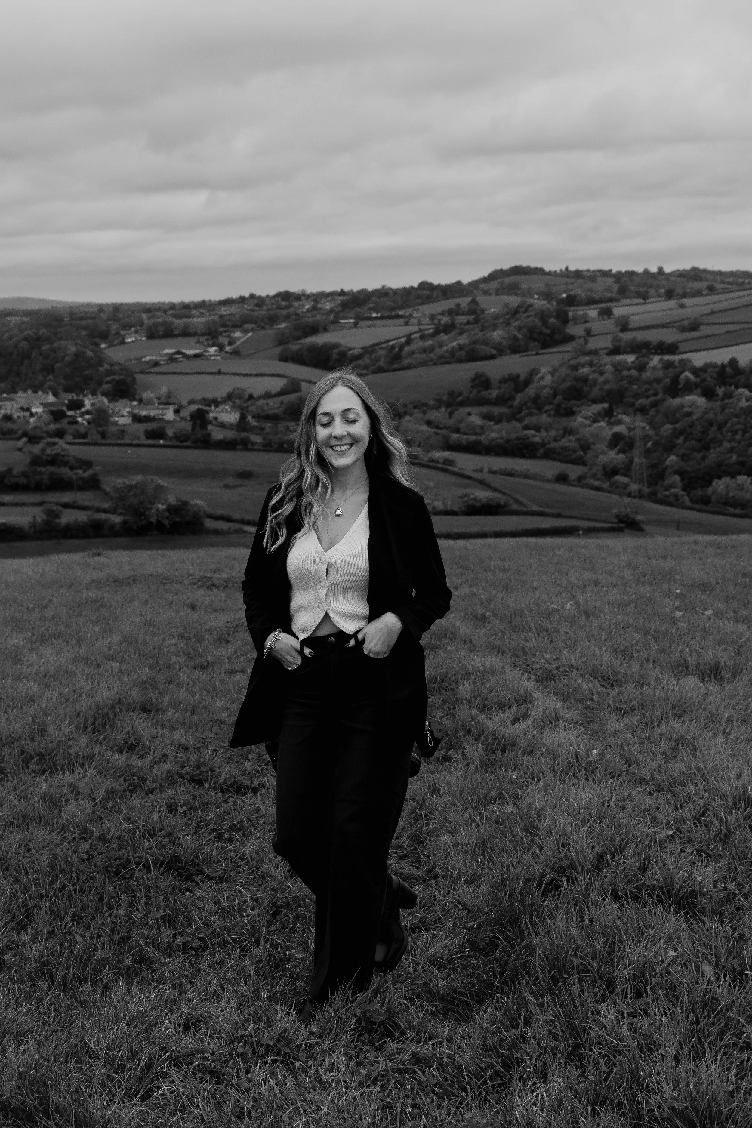 Somerset wedding and family photographer walking through countryside during a natural outdoor branding photoshoot.