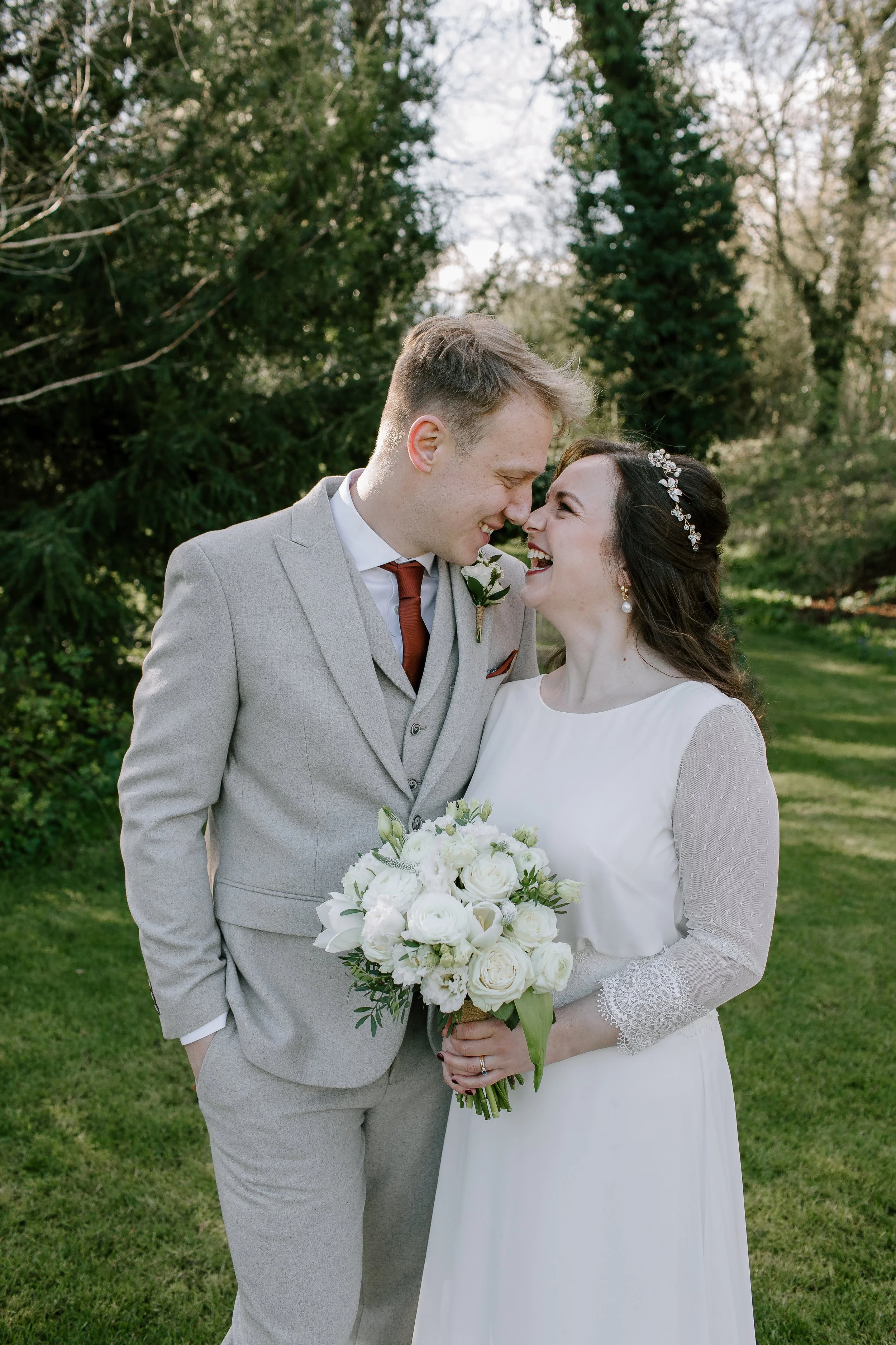 Intimate close-up wedding portrait of a bride and groom sharing a quiet moment during a Somerset countryside wedding.