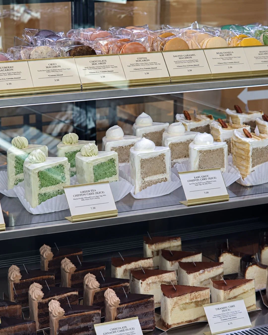 Macarons and assorted cake slices displayed at WOW Bakery West Springs.