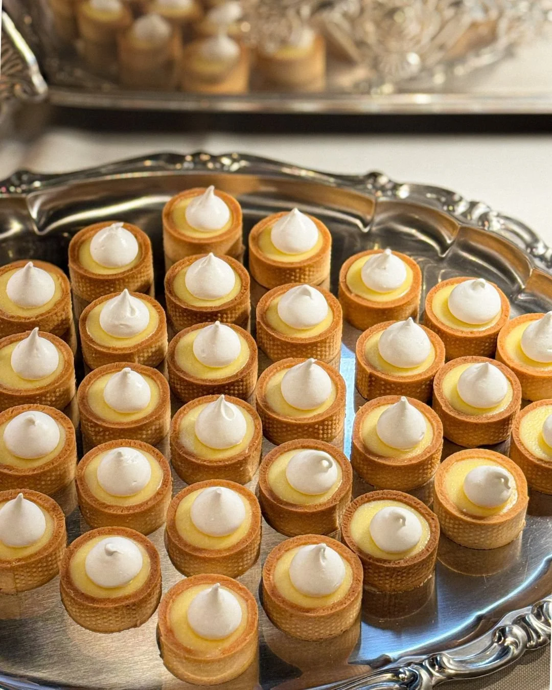 Lemon tarts topped with meringue served on WOW Bakery’s wedding dessert table in Calgary