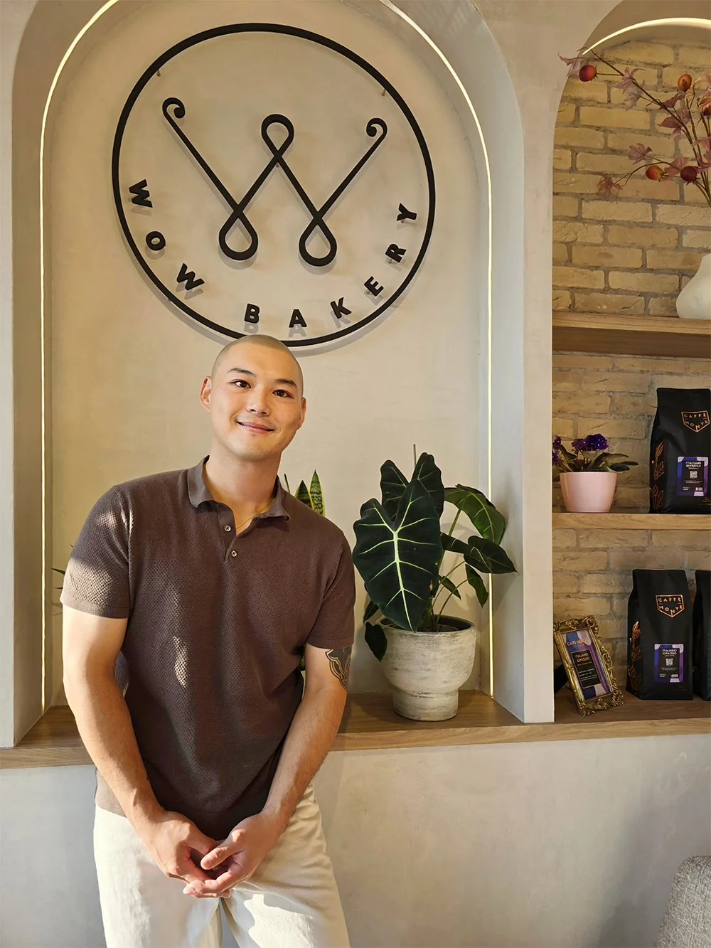 WOW Bakery co-founder and CEO Andrew Kim seated inside a WOW Bakery location in Calgary.