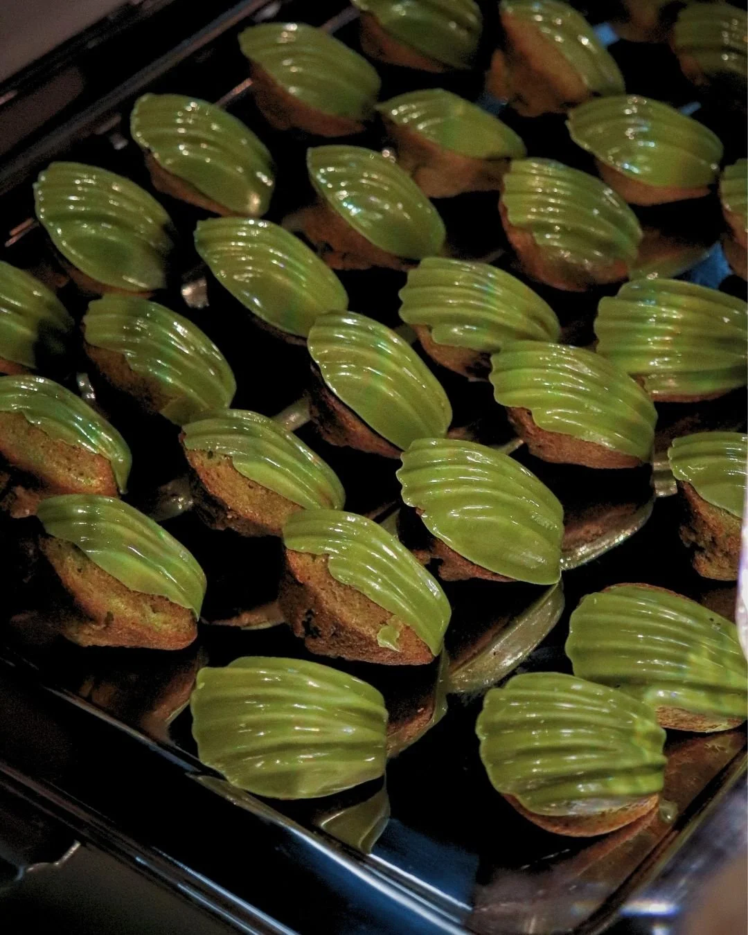 Matcha madeleines arranged on a dessert tray for WOW Bakery’s wedding catering event in Calgary