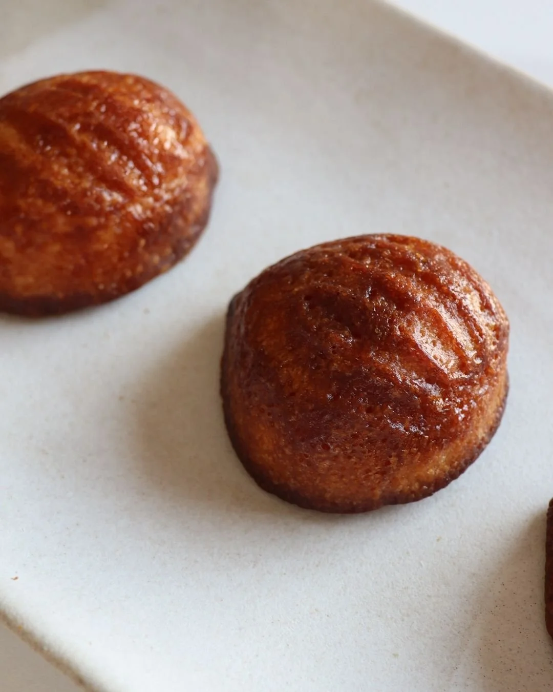 Close-up of a freshly baked Chewy Butter Mochi with a golden brown crust at WOW Bakery
