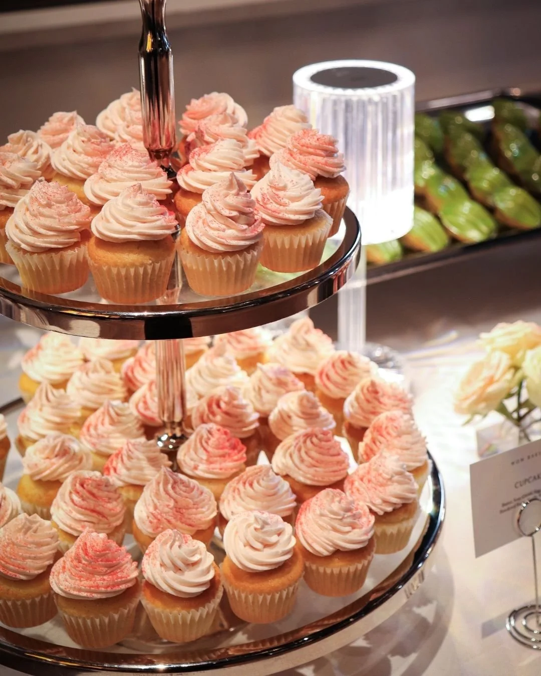 Cupcakes with pink frosting displayed on a tiered stand at WOW Bakery’s wedding dessert catering event in Calgary