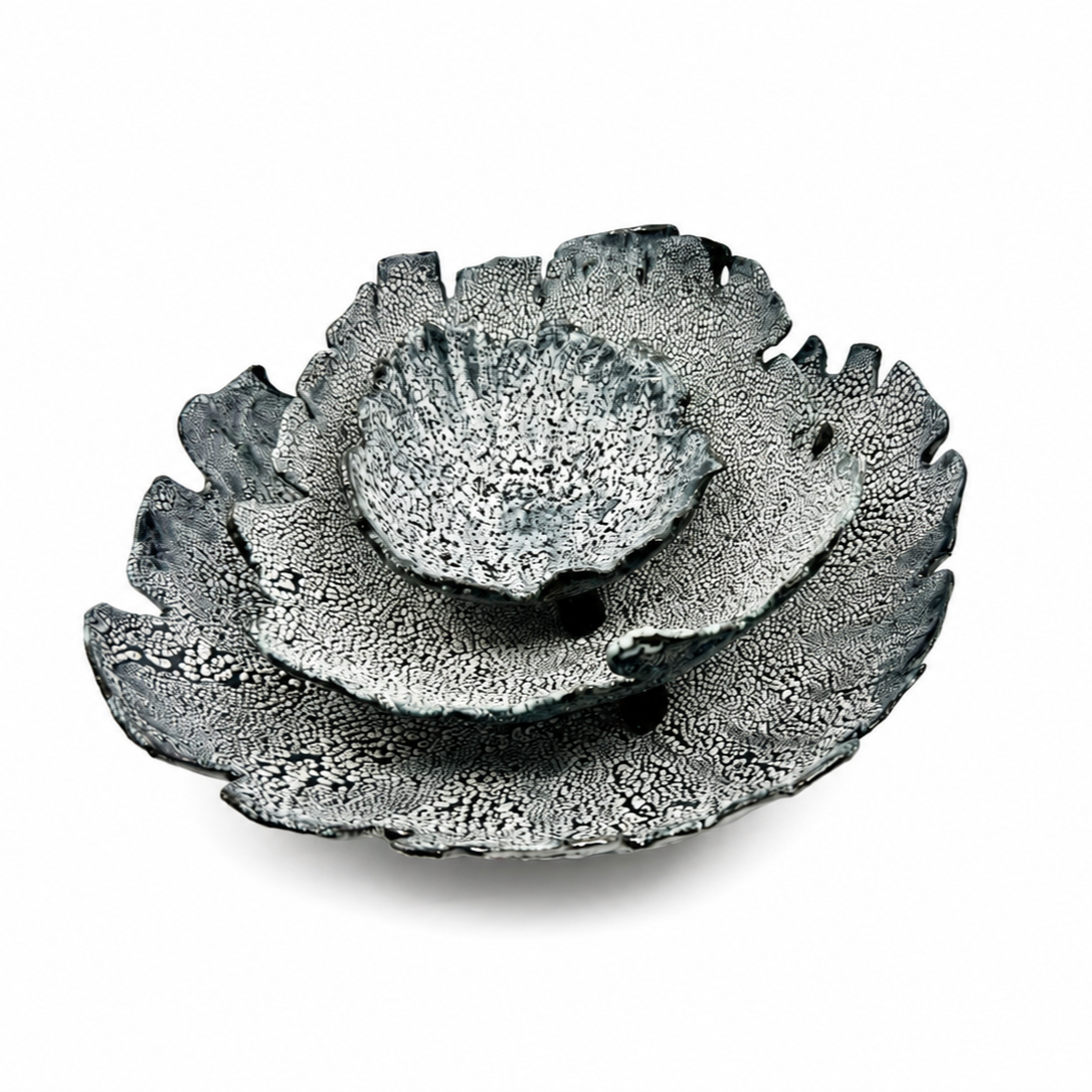 Decorative black and white ceramic flower-shaped bowl with intricate pattern.