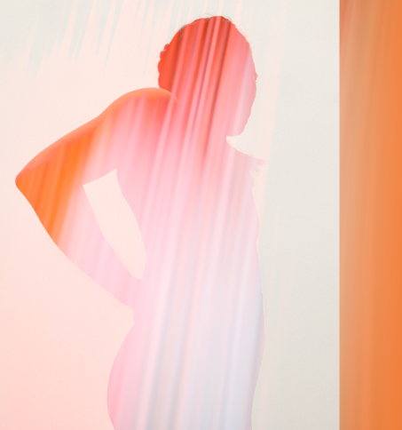 Silhouette of a woman standing with hands on hips in front of a pastel background with pink and orange vertical light streaks.