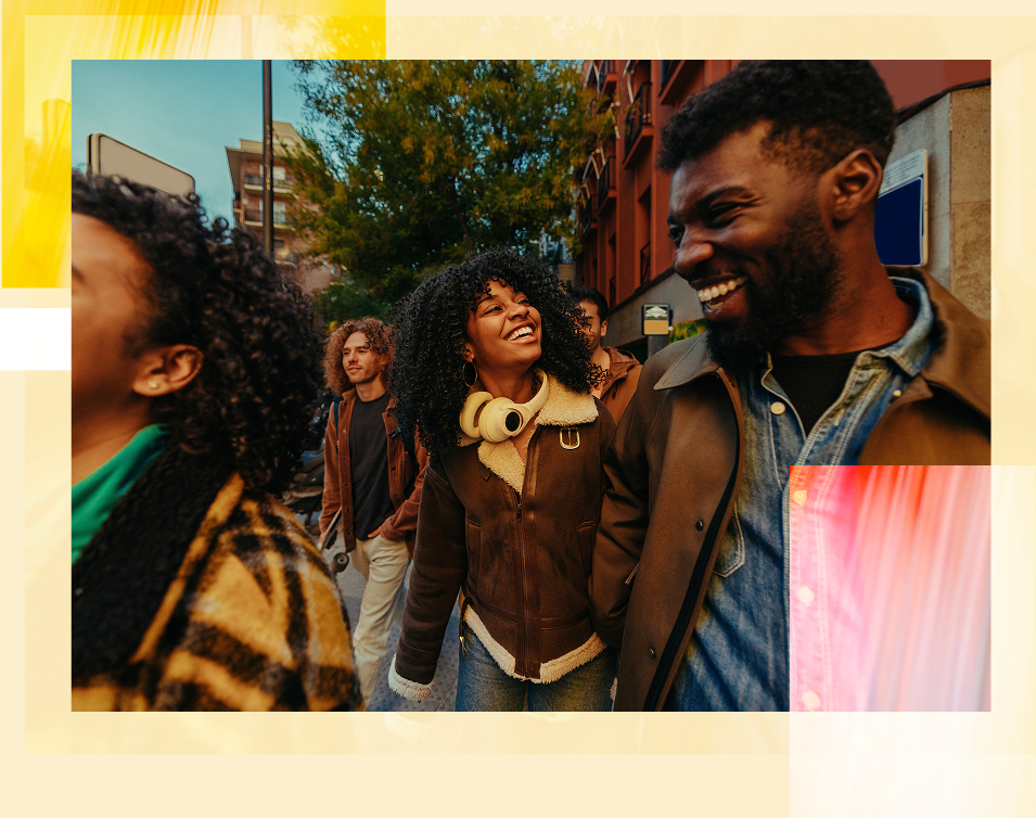Group of people laughing and enjoying each other's company outdoors in an urban setting during daytime