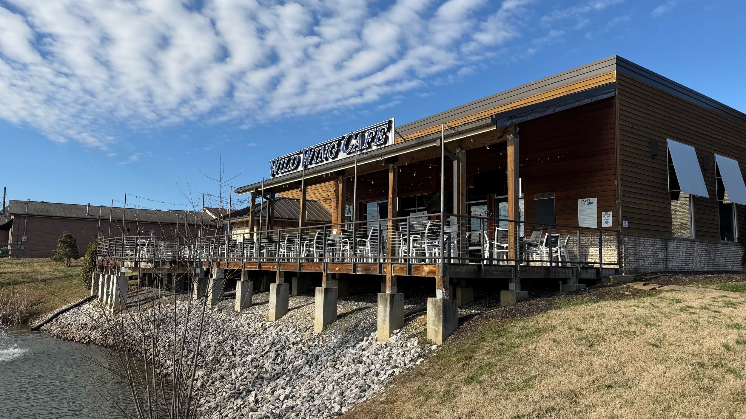 Wild Wing Cafe in Powell, Tennessee with a giant outside deck overlooking a small pond.