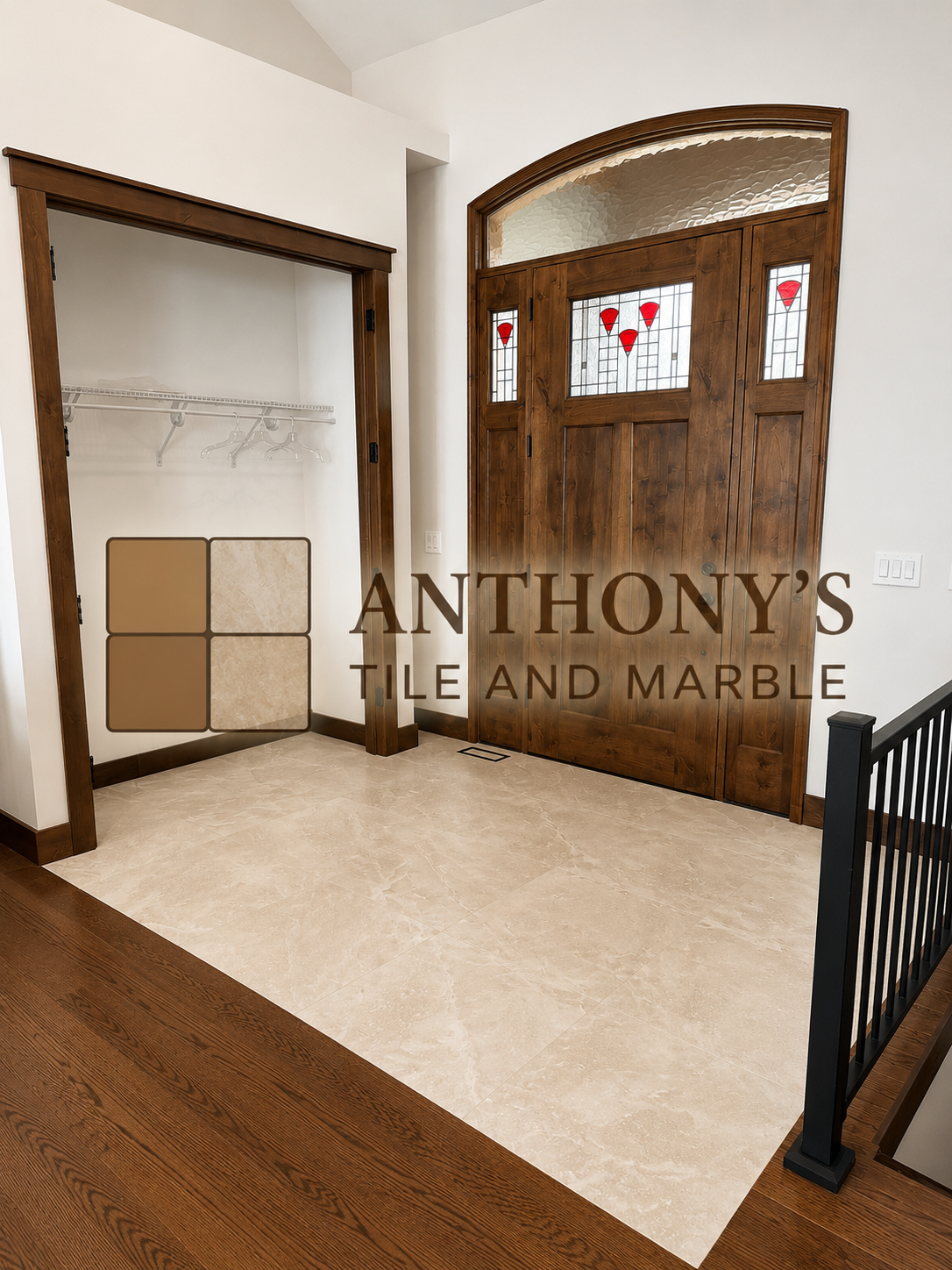 Entryway with wooden door featuring stained glass panels and an adjacent open closet with a wood frame, white walls, and beige tile flooring.