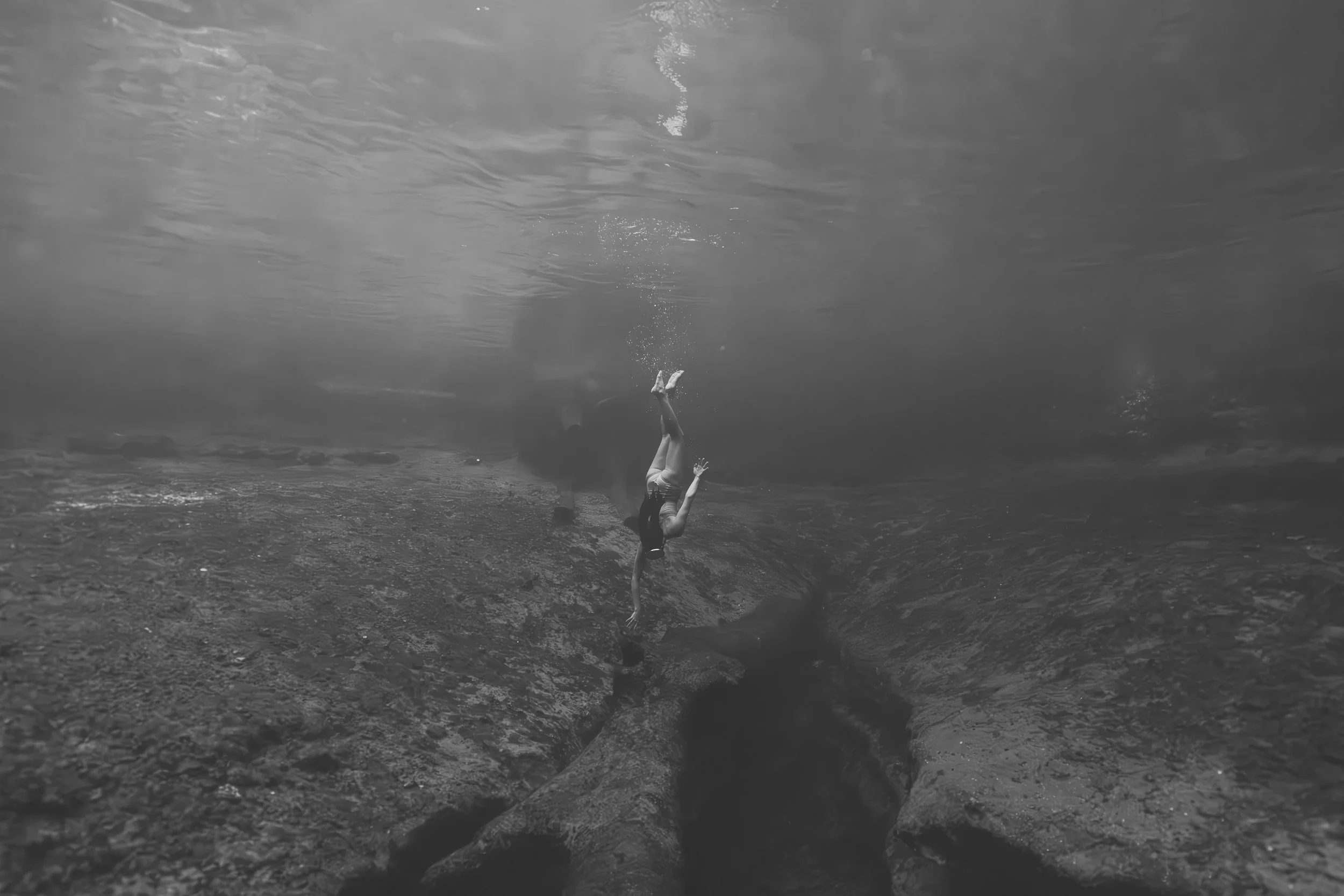 An underwater documentary & editorial image of a woman diving in Florida.