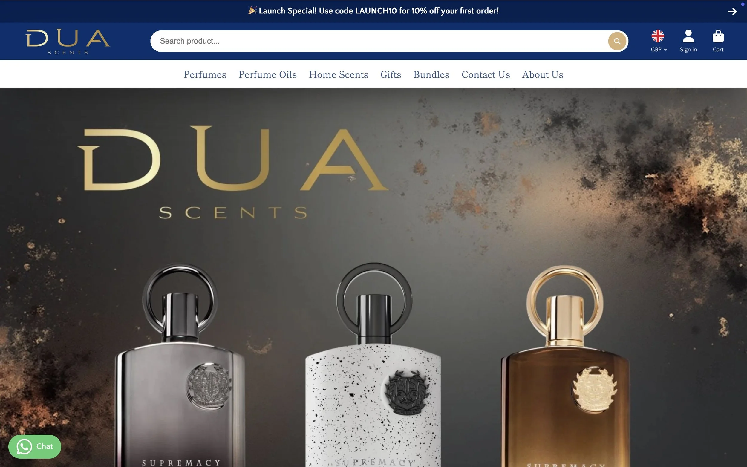 Homepage of DUA Scents website featuring three perfume bottles with gold, black, and silver caps against a dark background with gold and black splashes. The brand name 'DUA Scents' is displayed prominently.