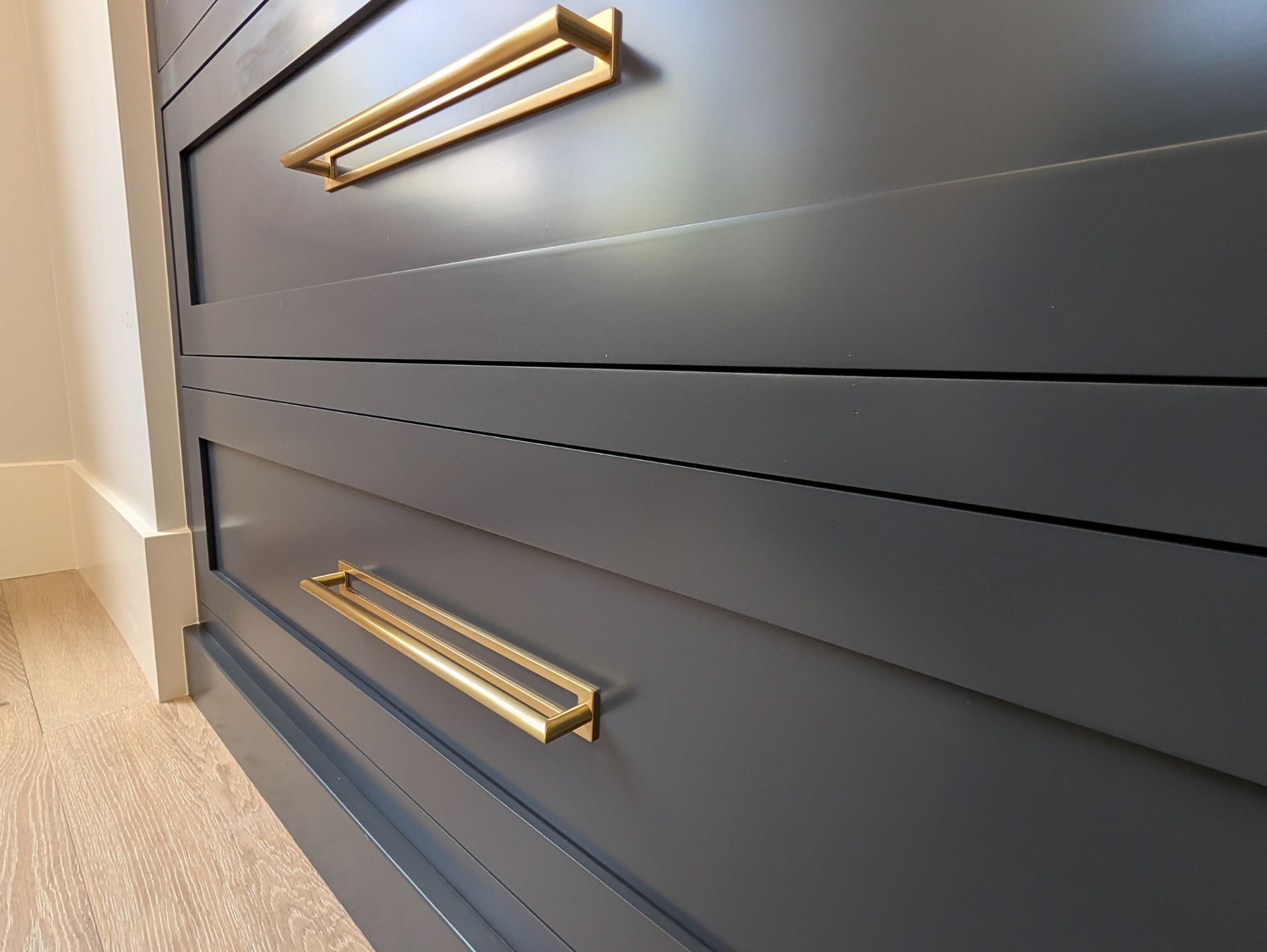 black kitchen cabinet drawer gold hardware.png