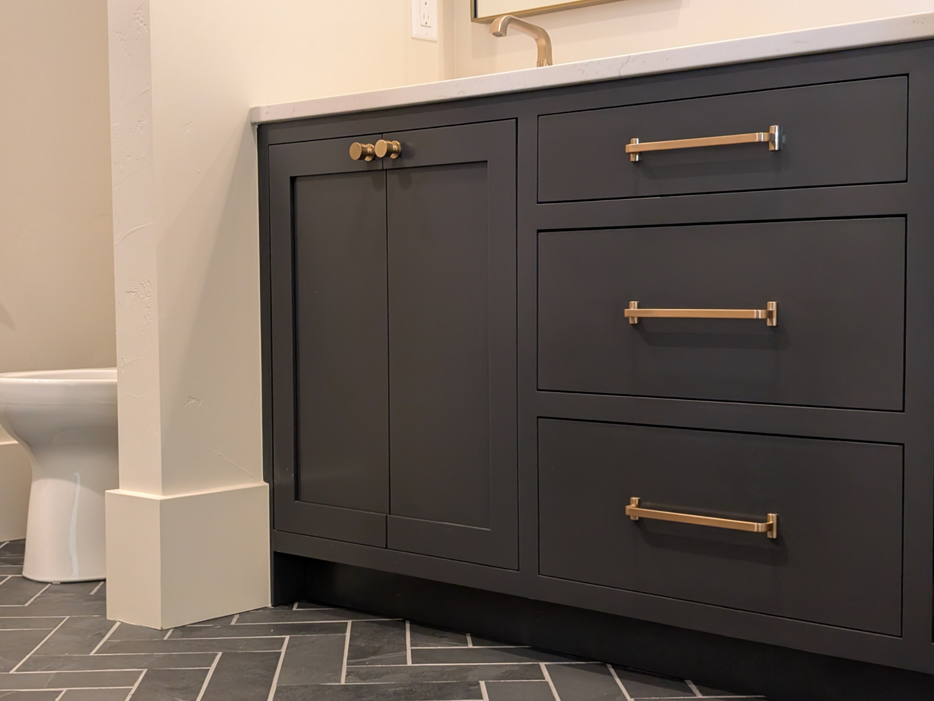 bathroom vanity with sink and toilet gold hardware.png