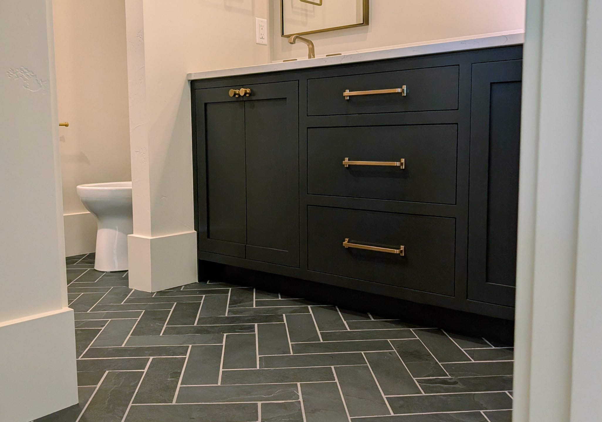 Bathroom vanity with sink and toilet.png