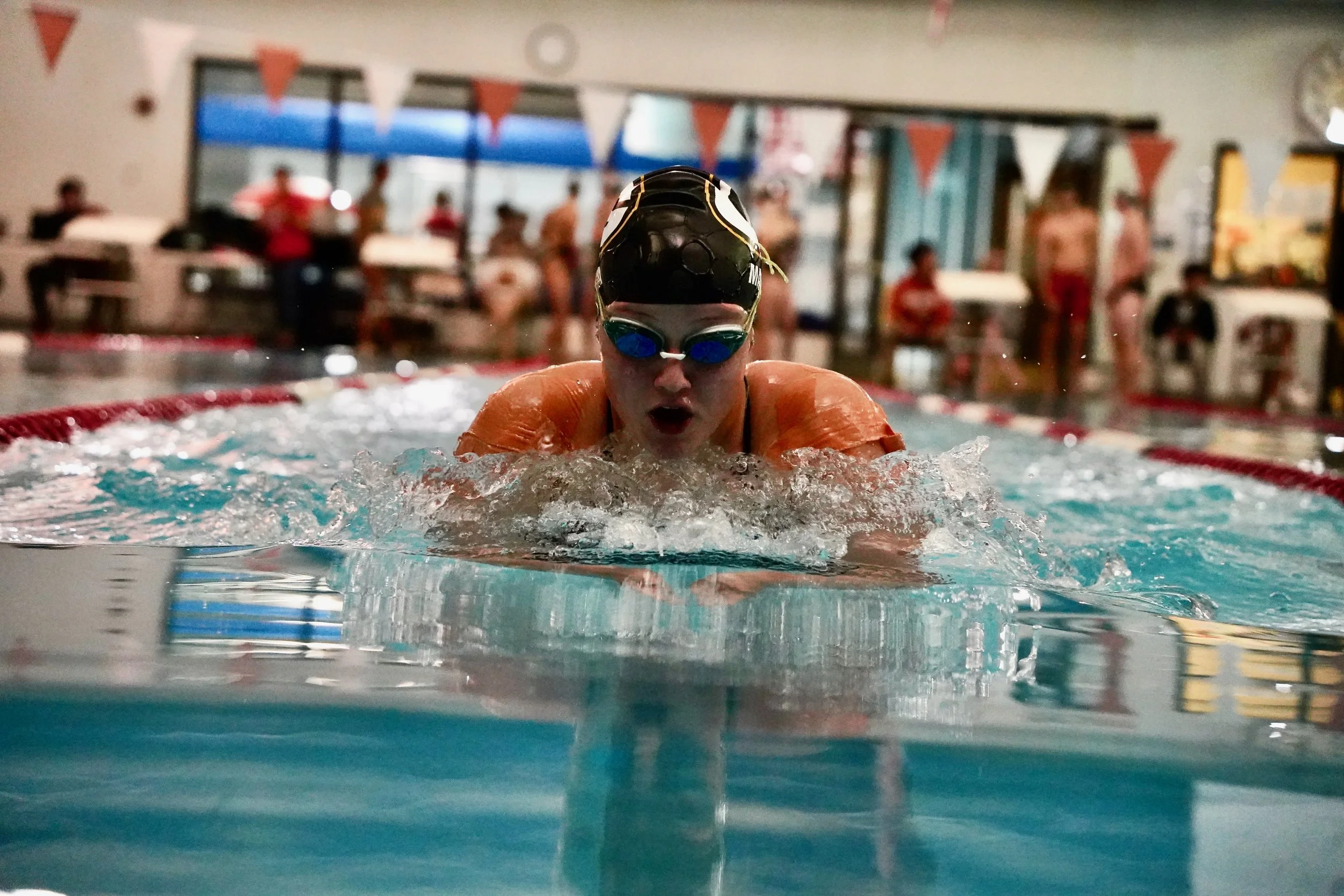 2023 - Rising from the water, junior Lily Matya presses down the lane during her 100-yard breaststroke against South Sioux City on Dec. 14. Matya finished first with a time of 1:20:90.