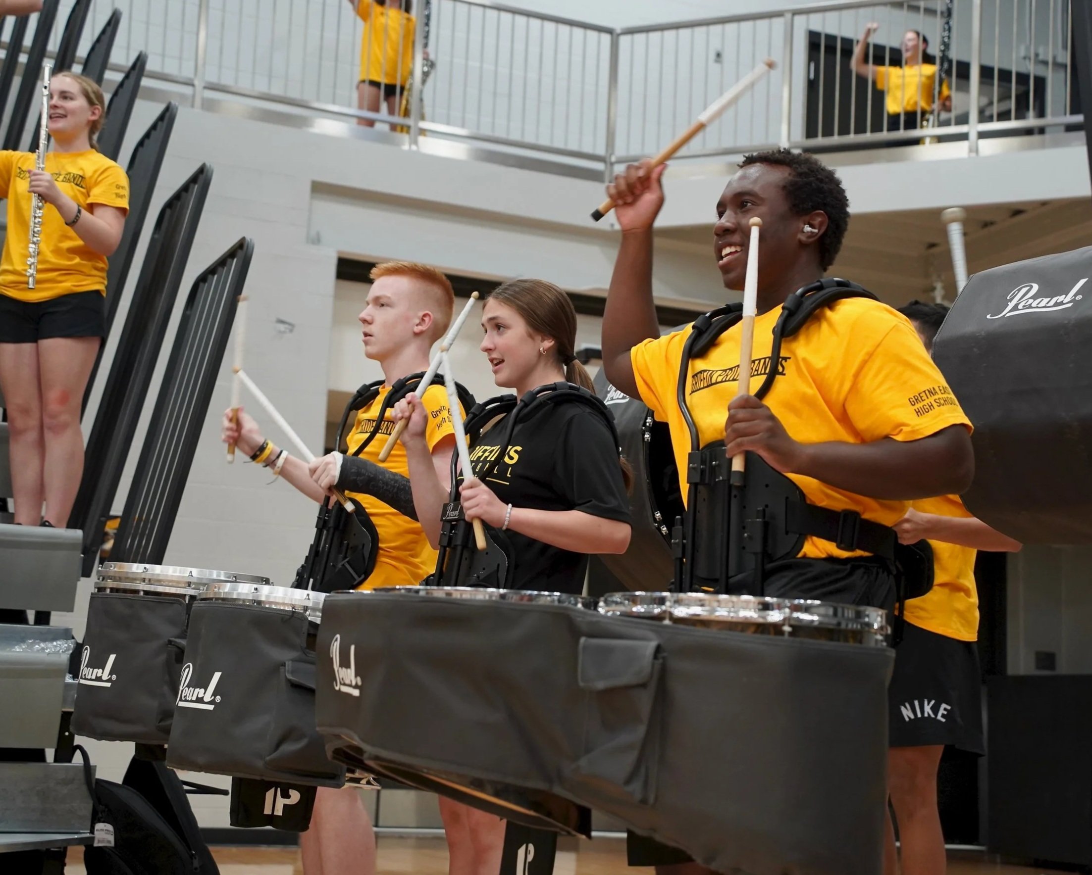 2025 - During the fall pep rally finale on Aug. 25, freshman Braden Daniels, sophomore Sabrina Nix and junior Timothy White perform the Griffin Fight Song as the dance and cheer teams complete their final routine.