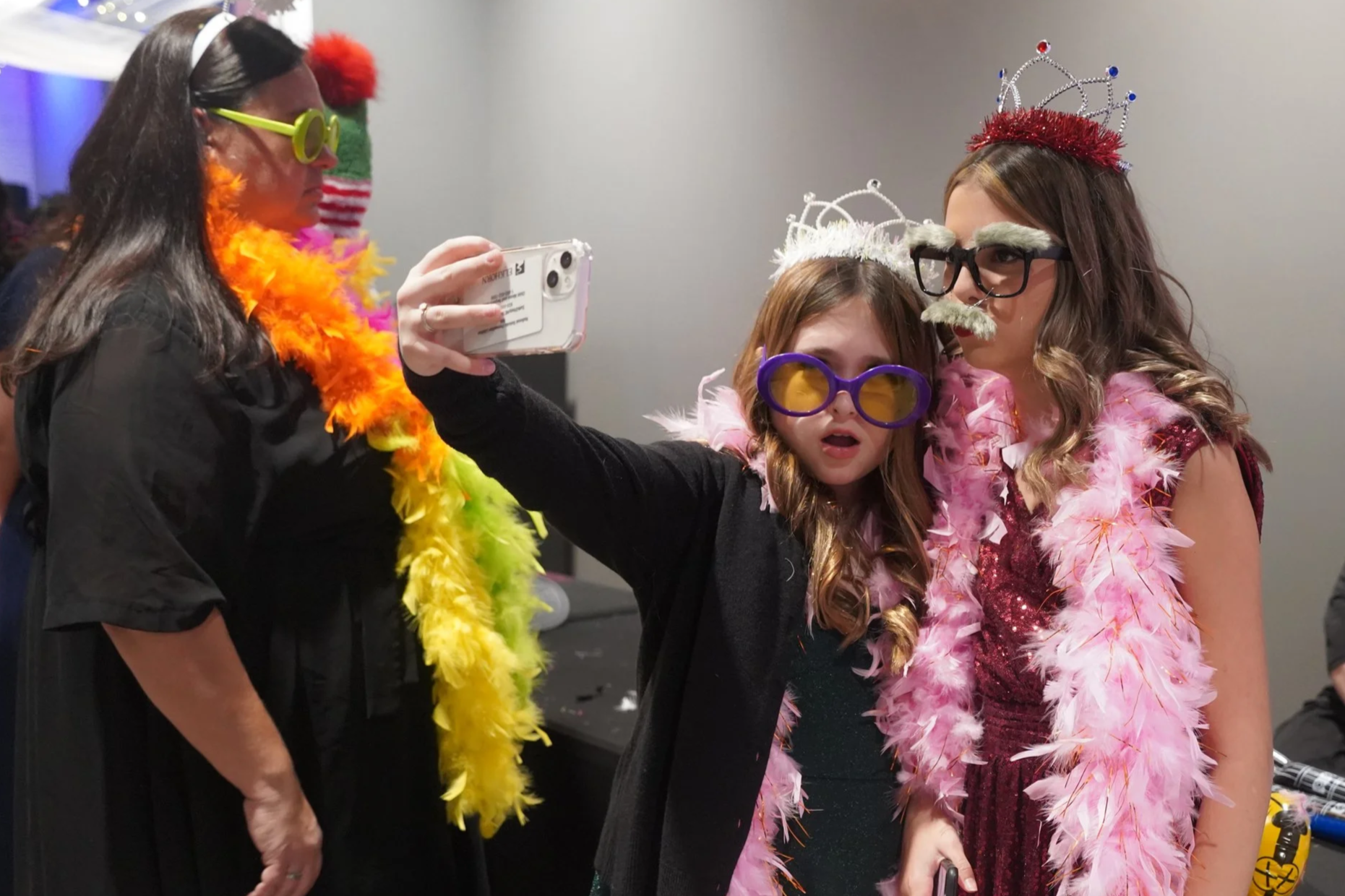 2023 - At the Ava's Army Ball on Dec. 2, two attendees take selfies with photo booth props. The annual ball honors childhood cancer victims and raises money for their treatment and research. The event featured activities for different age groups, fro