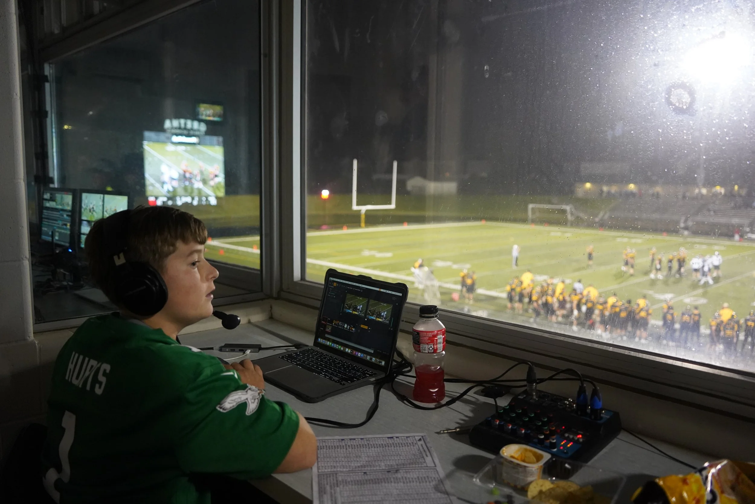 2025 - Assessing the field, freshman Jaxen Freyer makes the game calls for Gretna Live on Aug. 18. This was Freyer's first time working with the school's broadcasting team. He spent over an hour before the game practicing pronouncing every player's n