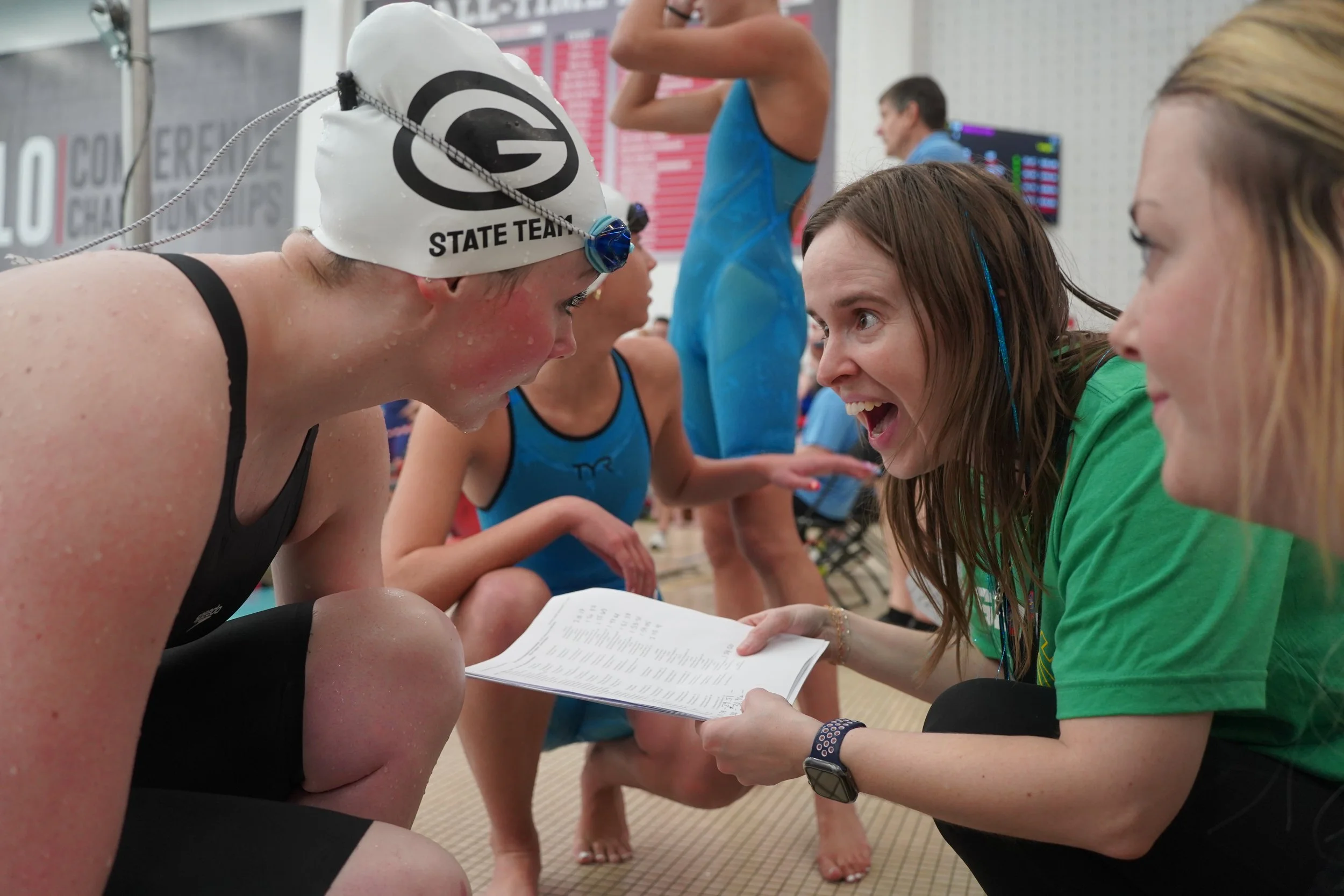 2026 - Talking with Head Swim Coach Kari Meister on Feb. 27, sophomore Mya Hallgren learns she advanced to the state swimming finals in the 50-yard freestyle. Hallgren tied for 17th place and had to compete in a swim-off to determine if she went to t