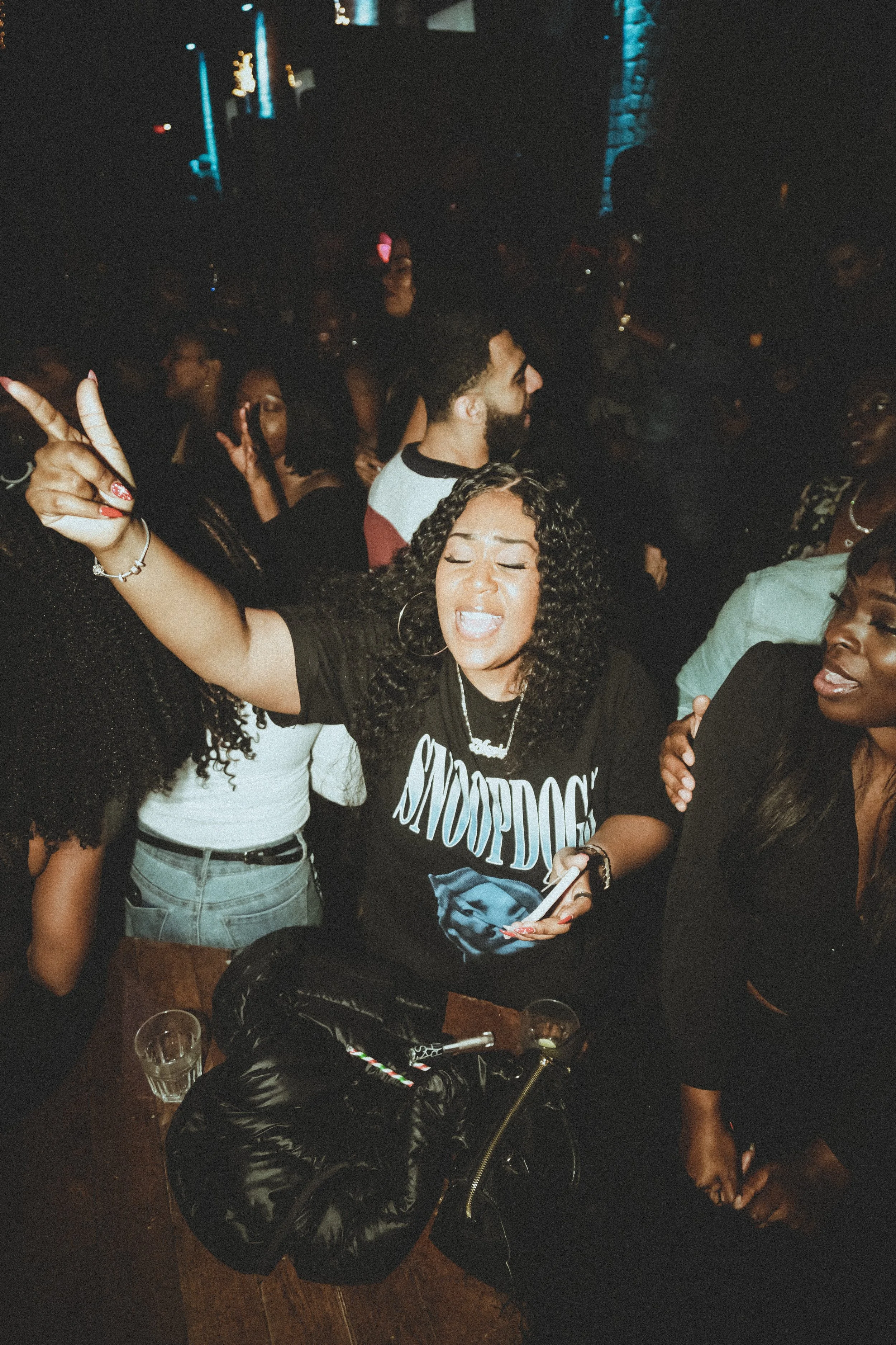 A guest singing and dancing on a crowded dance floor at That Slow Jam Party, a grown-and-sexy R&B event in Toronto celebrating classic and modern slow jams.