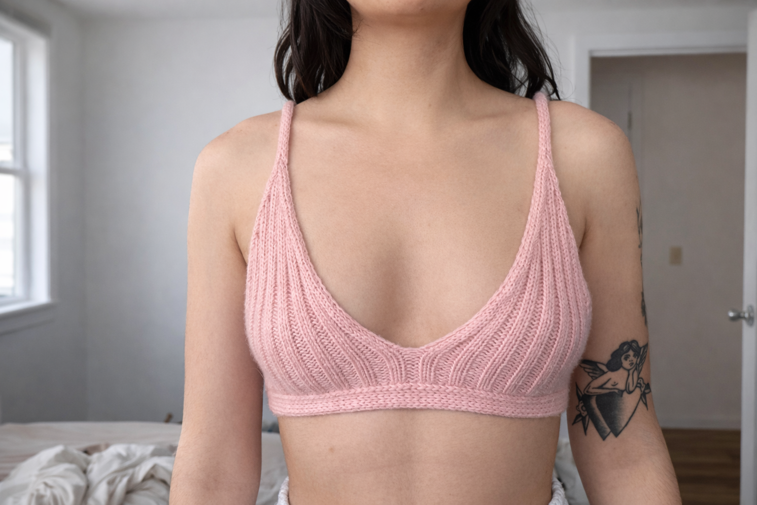 Pink bralette in sunlit bedroom.png