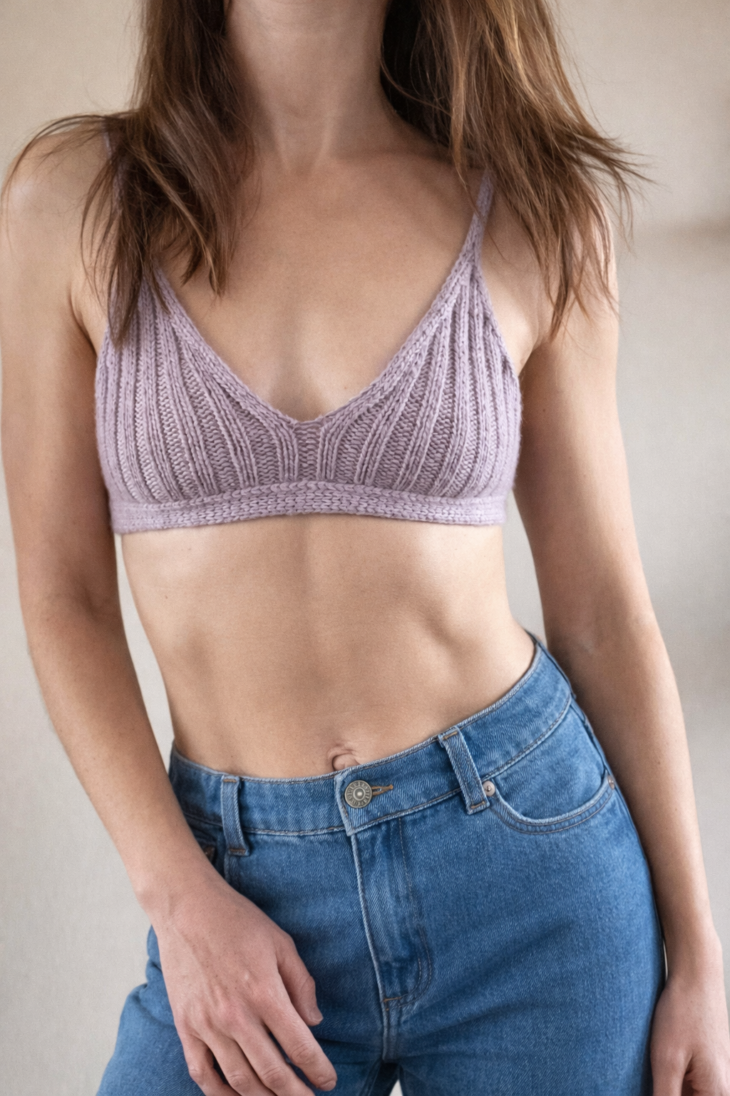 Woman wearing lilac purple handknit bralette
