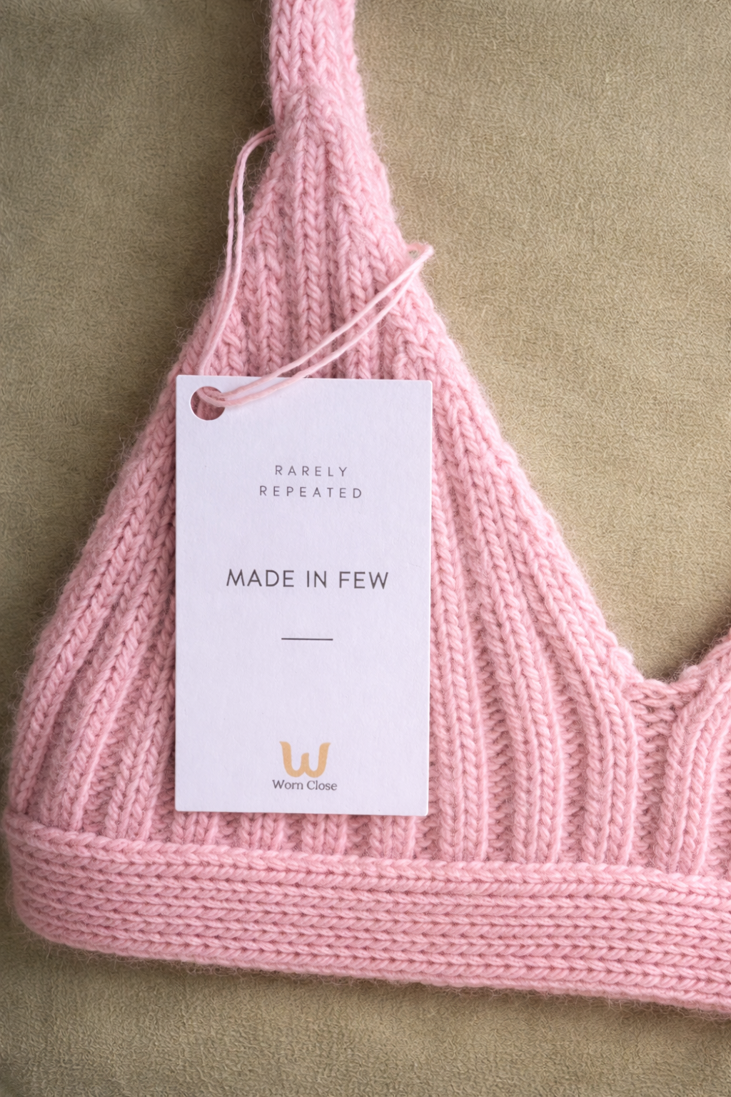 Pastel pink bralette with tag detail.png