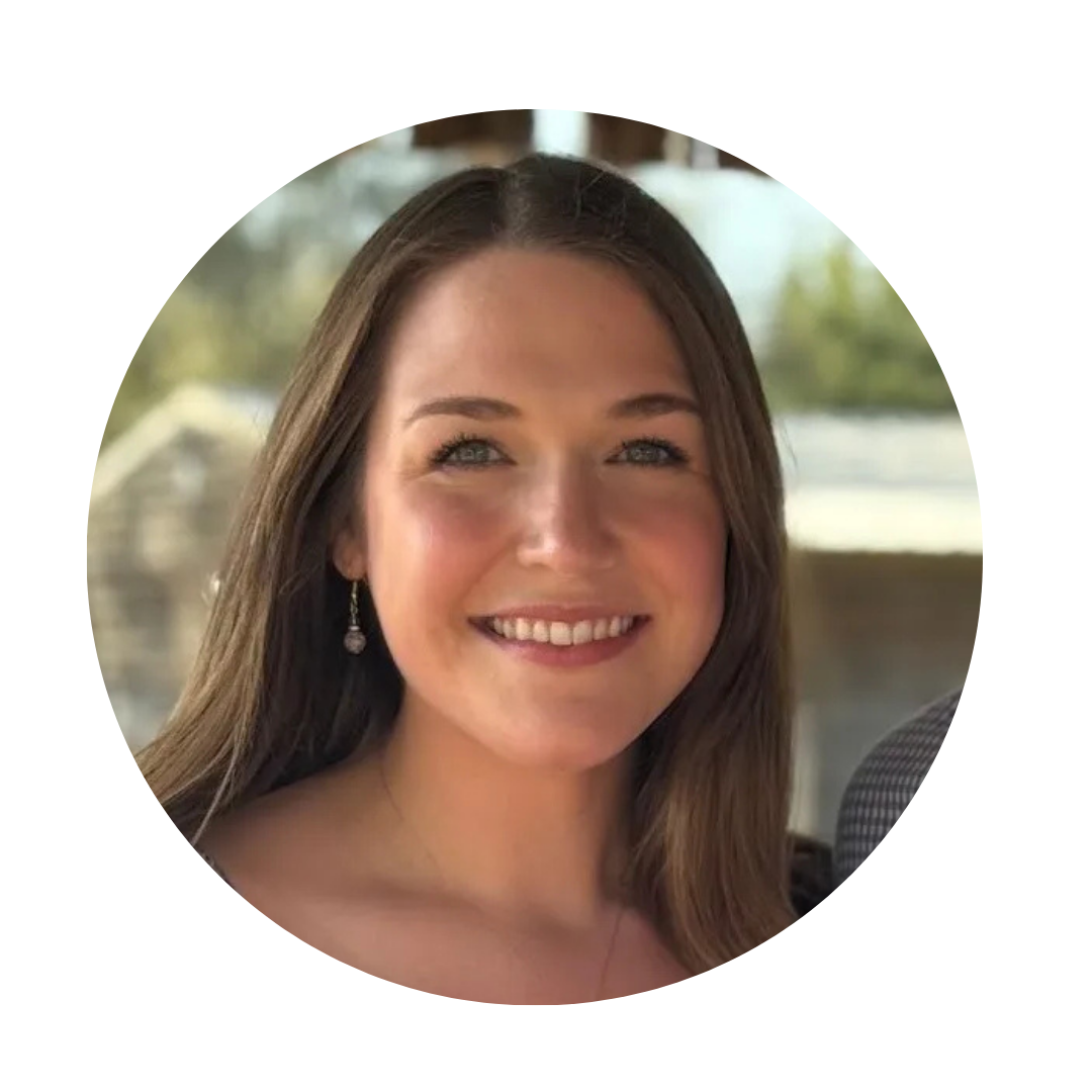 Close-up of a smiling woman with long brown hair and earrings.