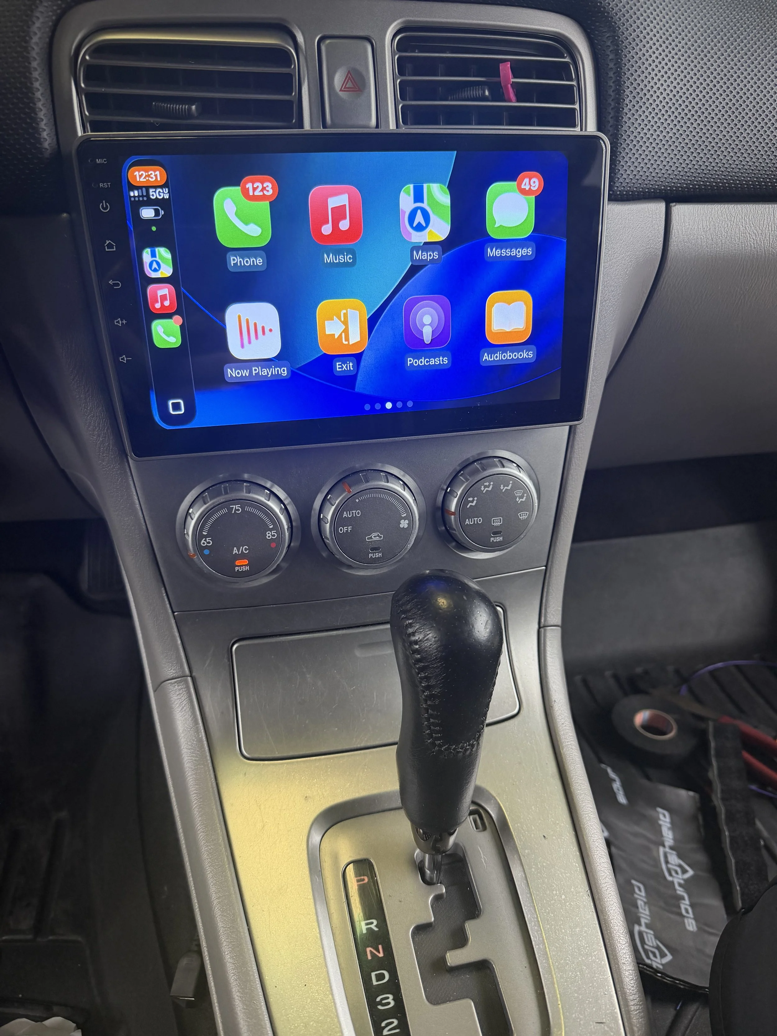 Apple CarPlay head unit installed in a customer vehicle with professional integration and factory-style finish.