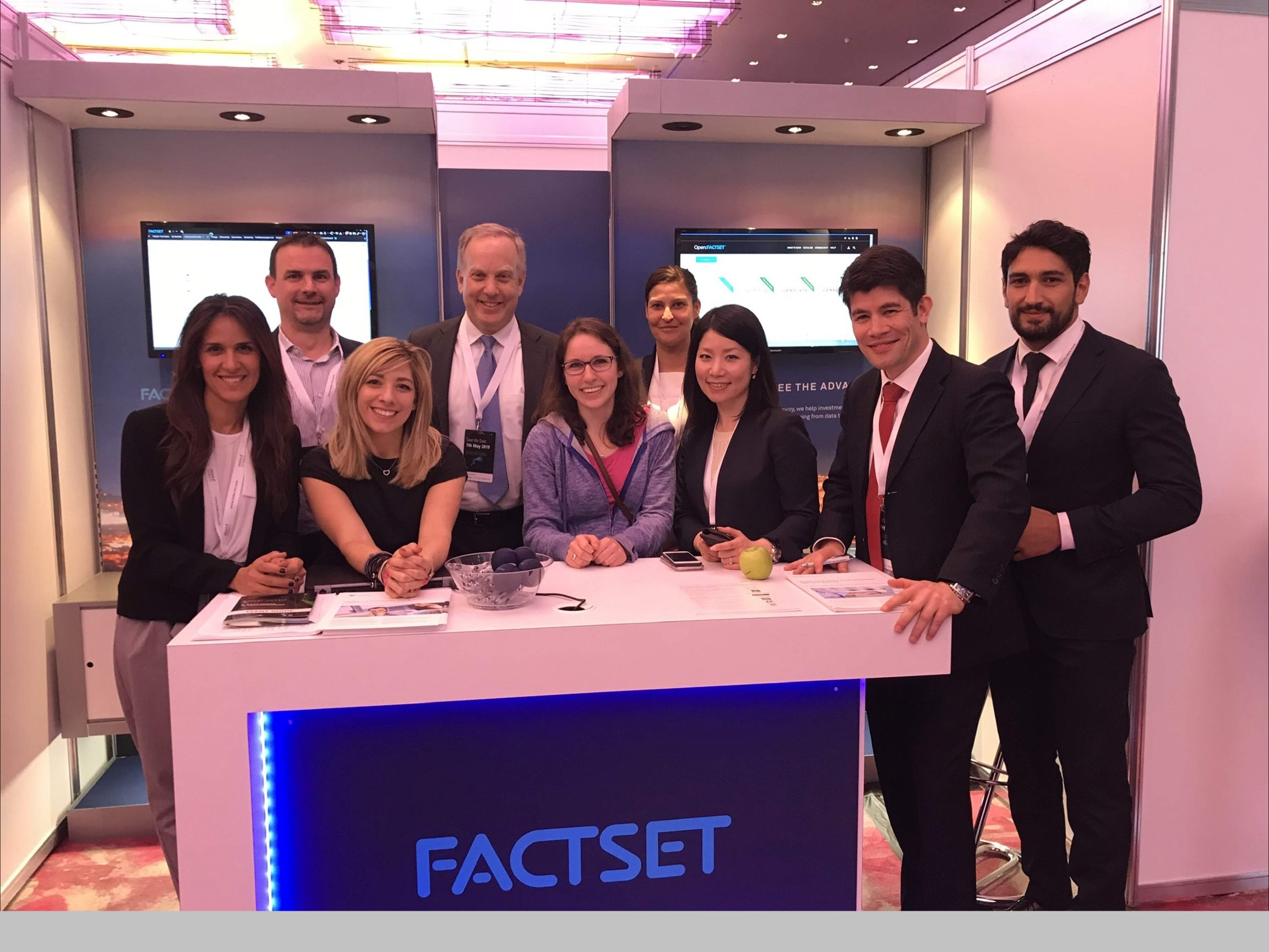 Rich speaking at FactSet event in Munich, Germany, 2018.  Jessica, who was teaching in Cologne, came to visit and joined the picture at the FactSet booth.