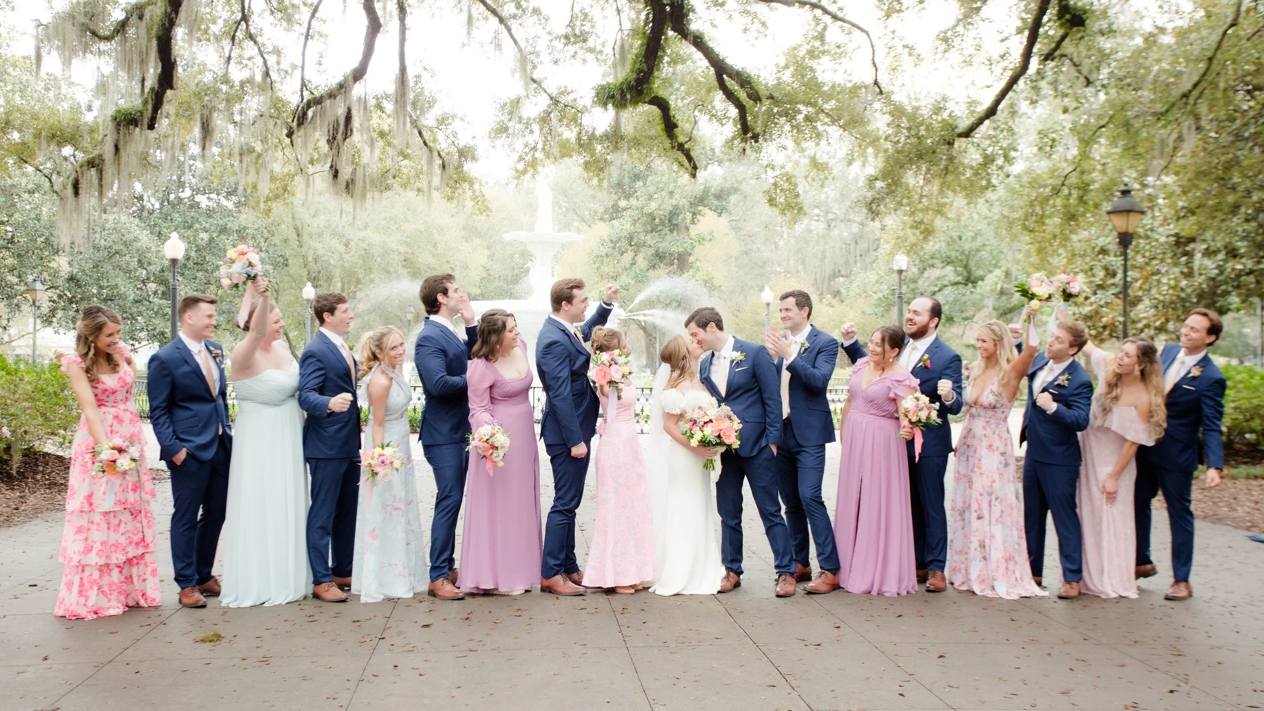 Jacly & Price's wedding party pose before the fountain at Forsyth Park in Savannah, Georgia.