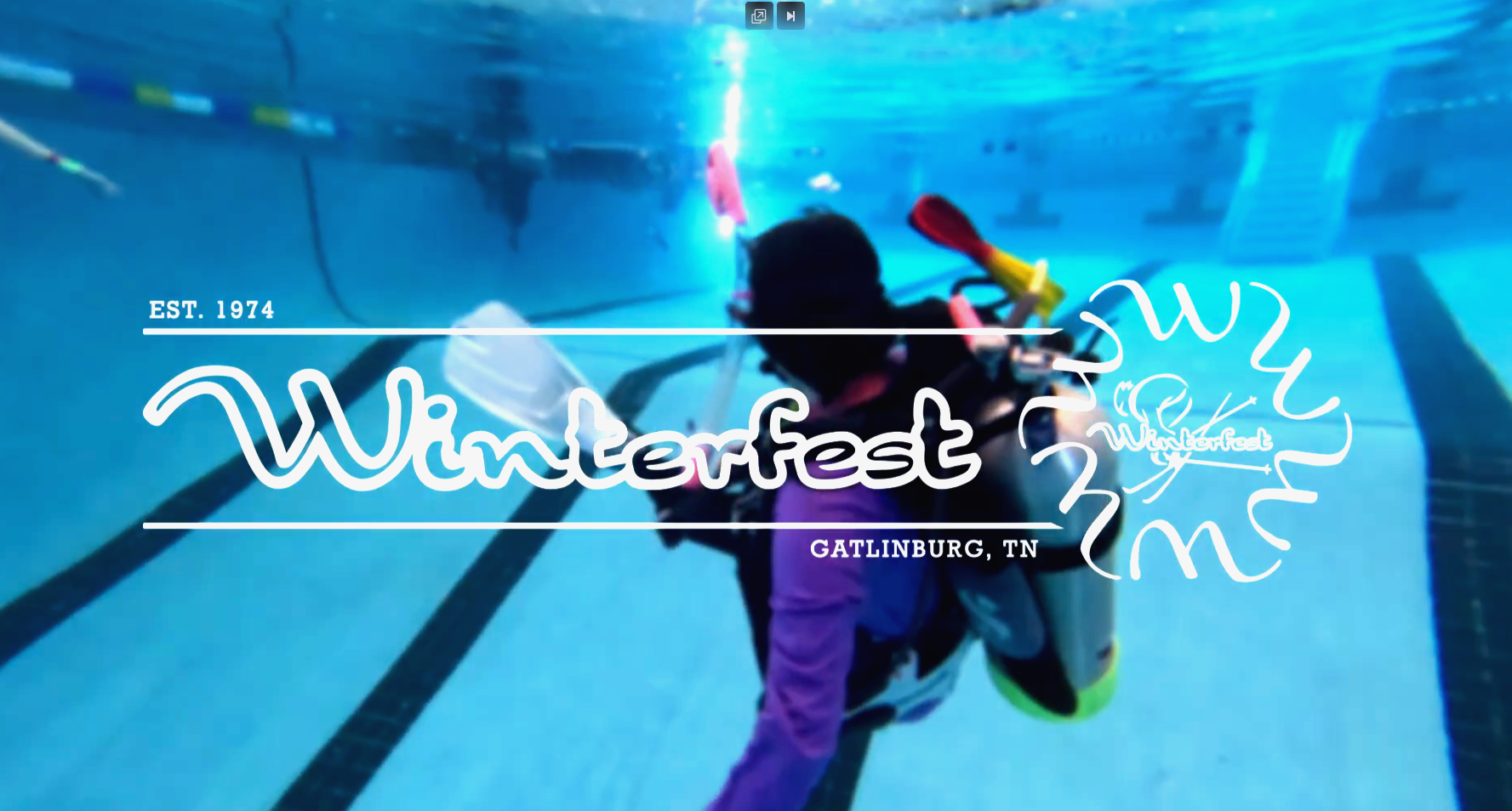 Underwater view of a person in diving gear with a helmet, surrounded by pool lanes, promoting Winterfest event in Gatlinburg, Tennessee, established in 1974.