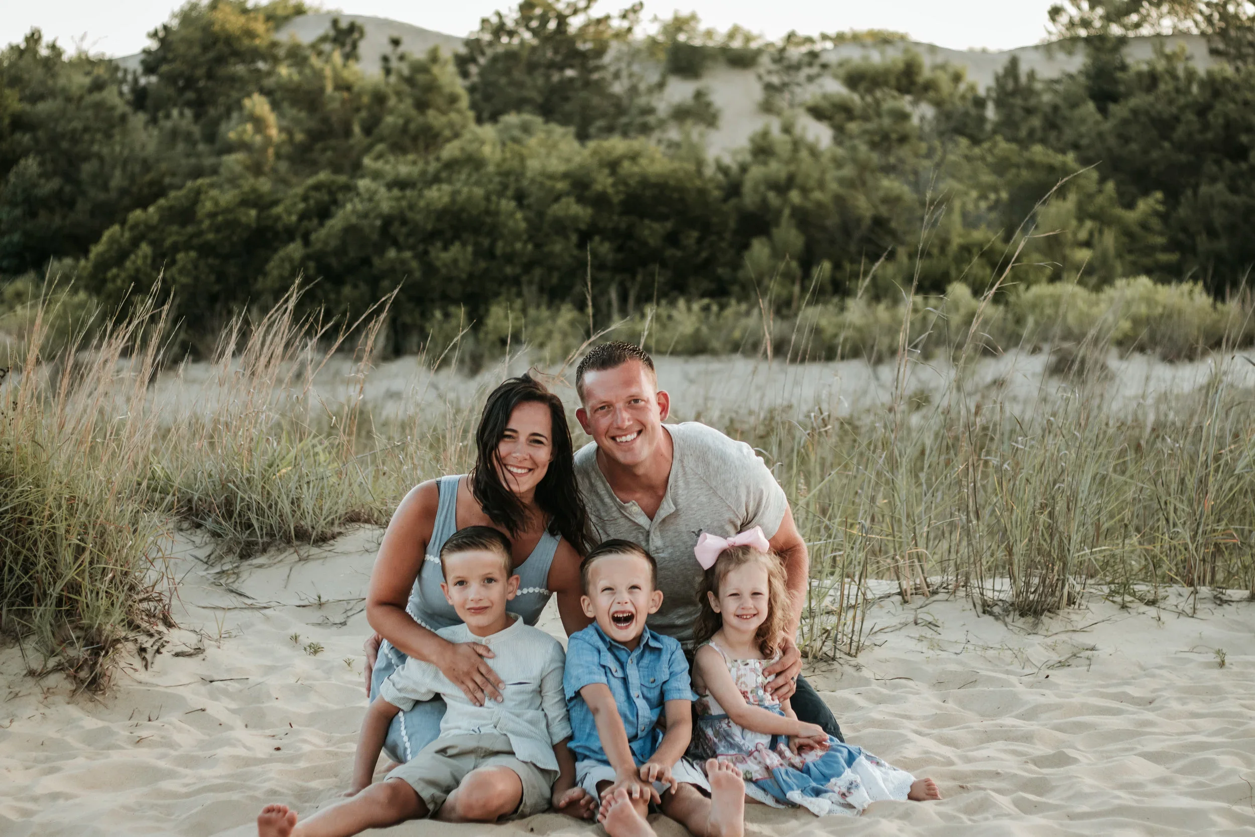 Kristen with her husband and kids on the beach