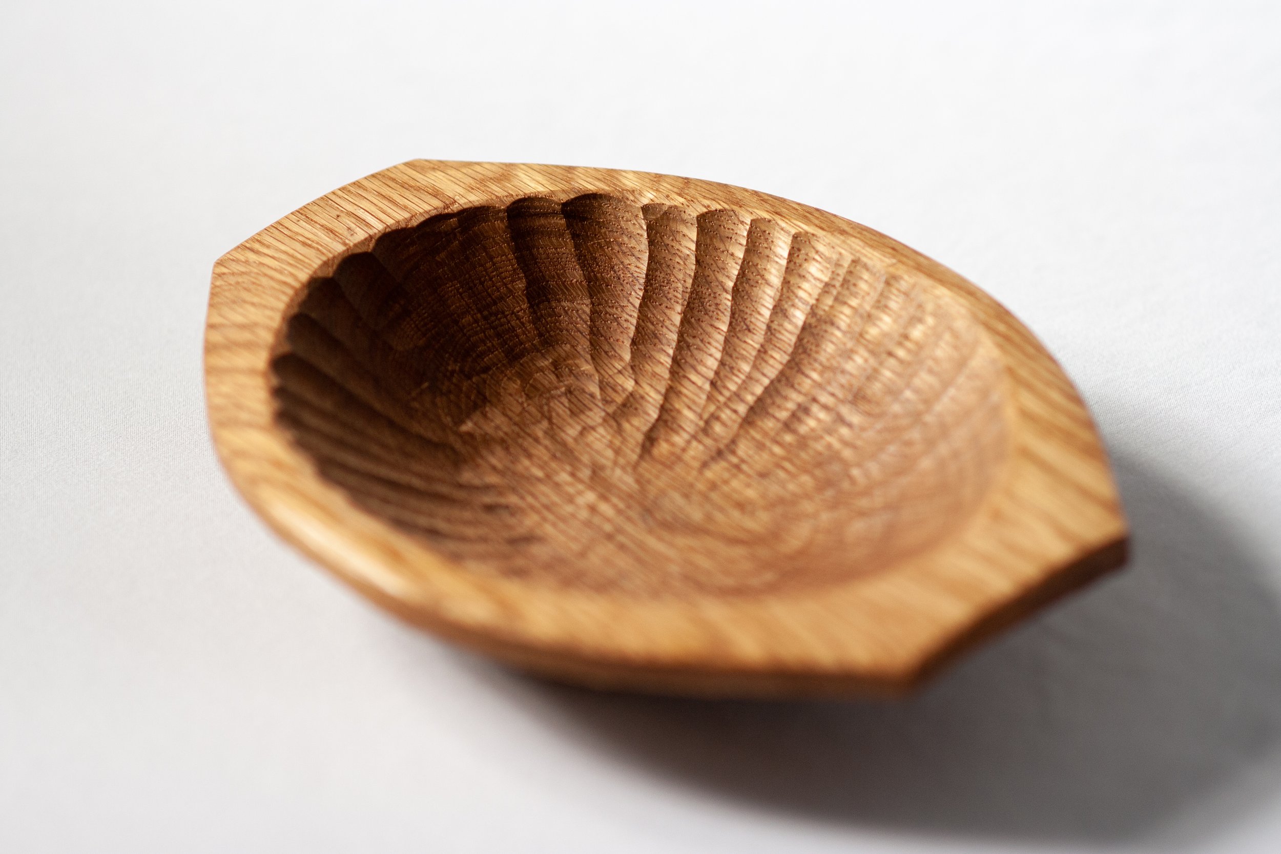 Starburst Bowl | Shallow, elliptical handled bowl carved from reclaimed white oak with a starburst gouge pattern. 