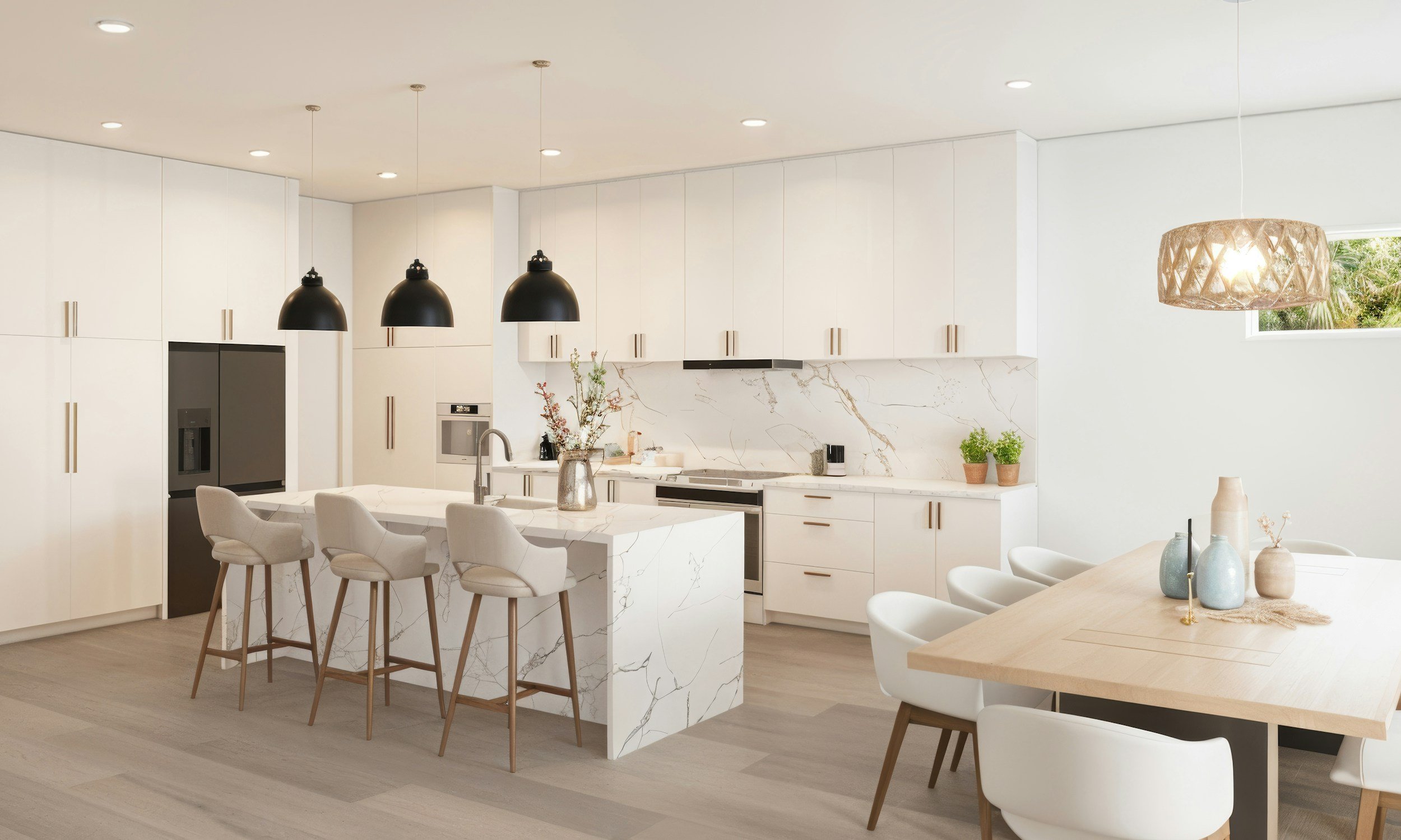 Modern kitchen with white cabinetry, marble countertops, black pendant lights, and a wooden dining table with white chairs.