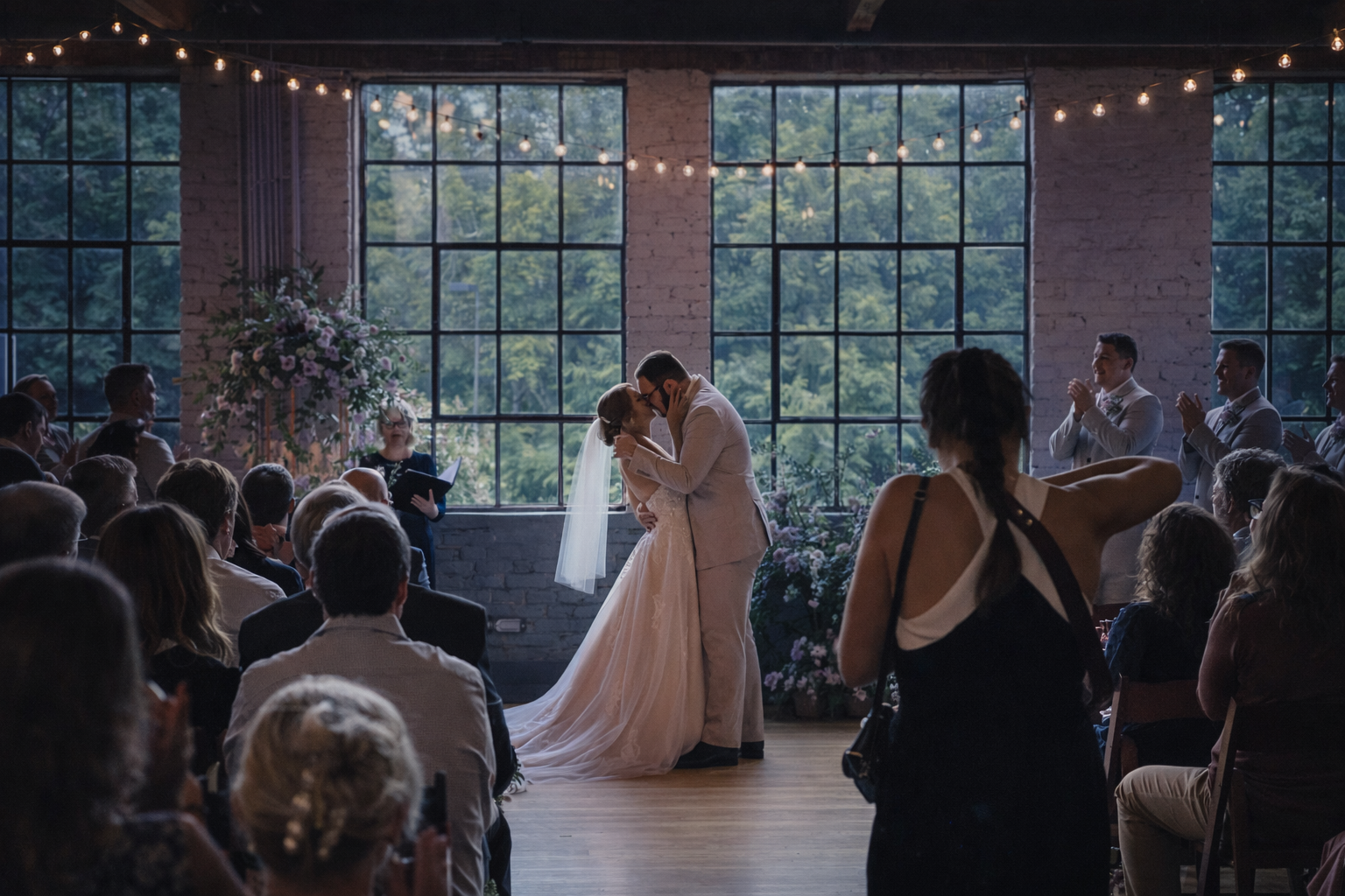 Bride and groom walking into their wedding ceremony space in Chapel Hill as guests look on.