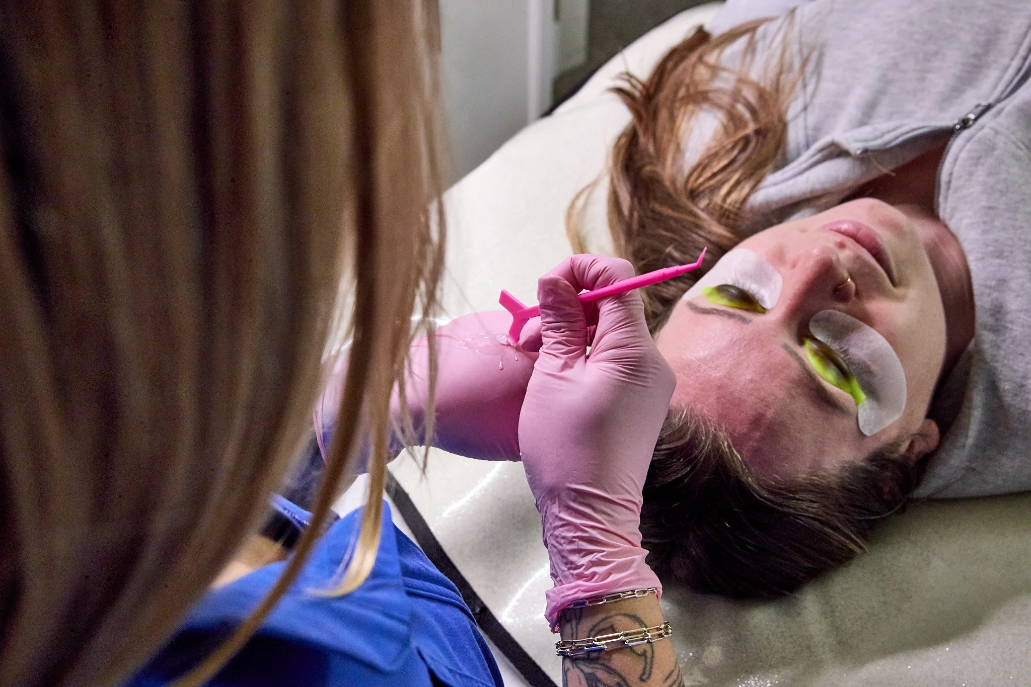 Laurie’s customers, Mariana and Carmen holding hands on a green lawn on their wedding day.