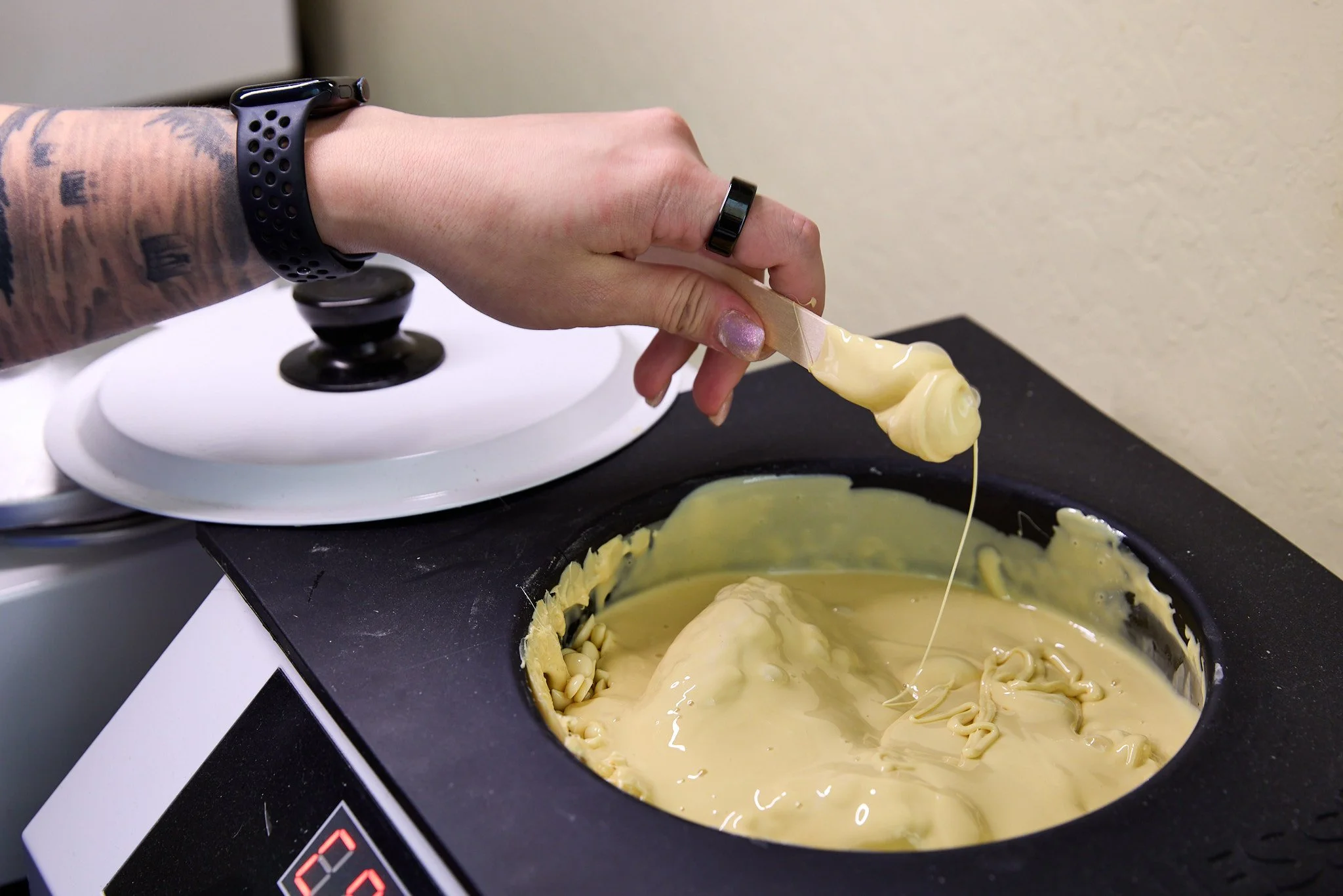 Rachel preps fresh wax for hair removal.