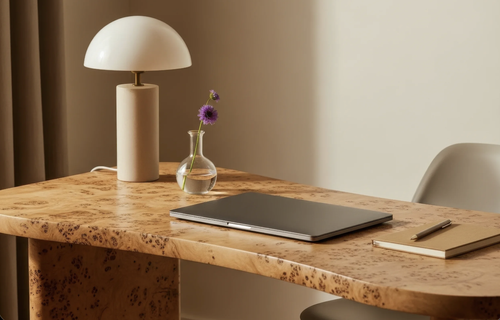 Desk with notebook, laptop, and lamp