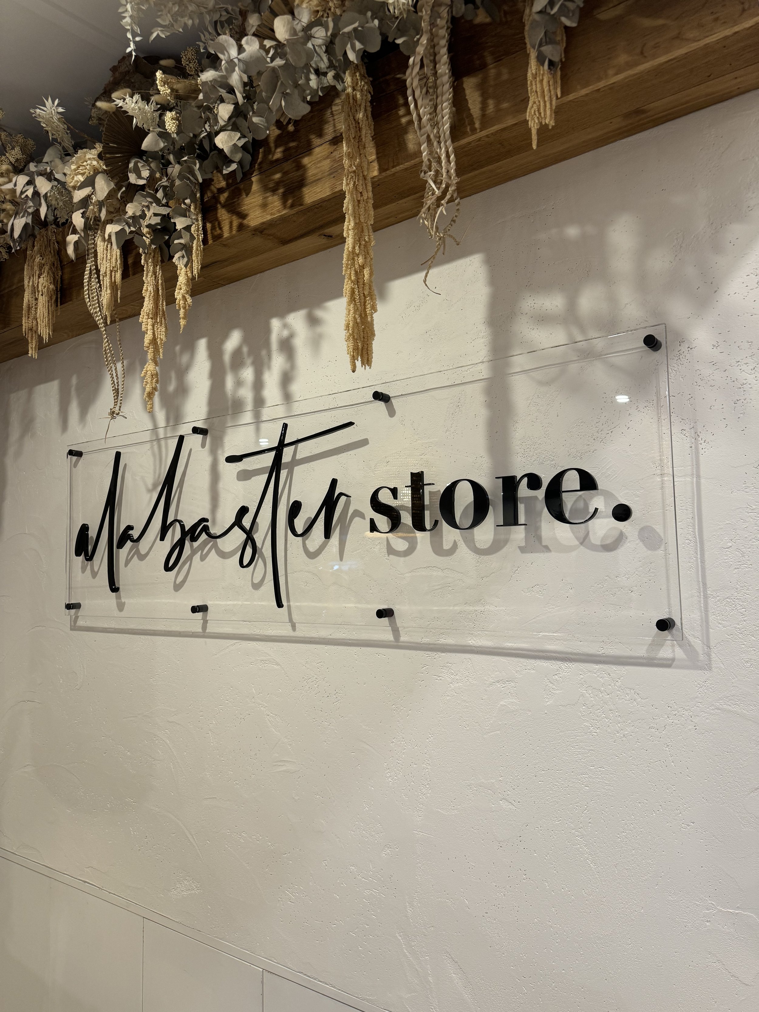 Clear acrylic panel with laser cut black acrylic lettering reception wall sign.