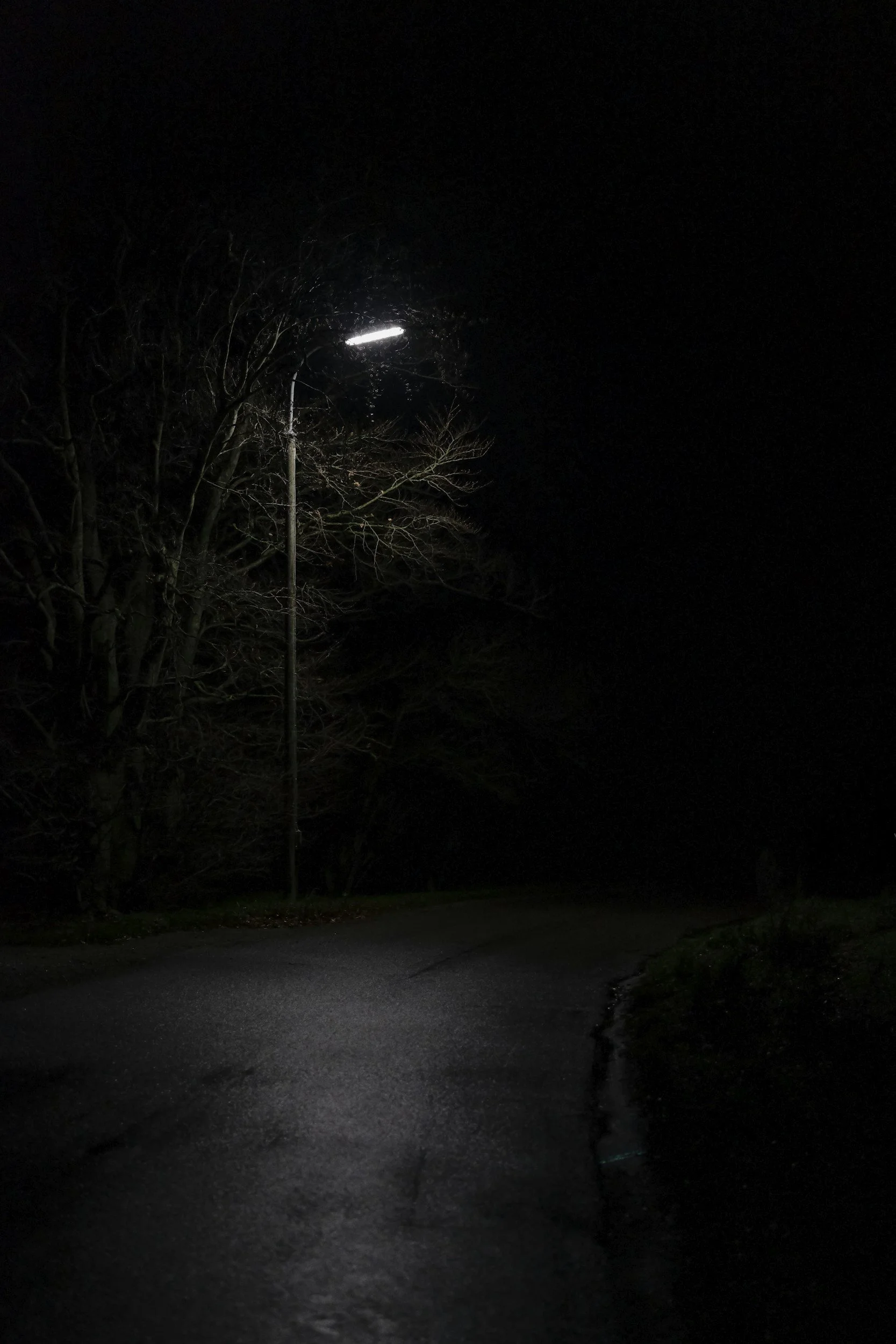 Dark street with one street lamp
